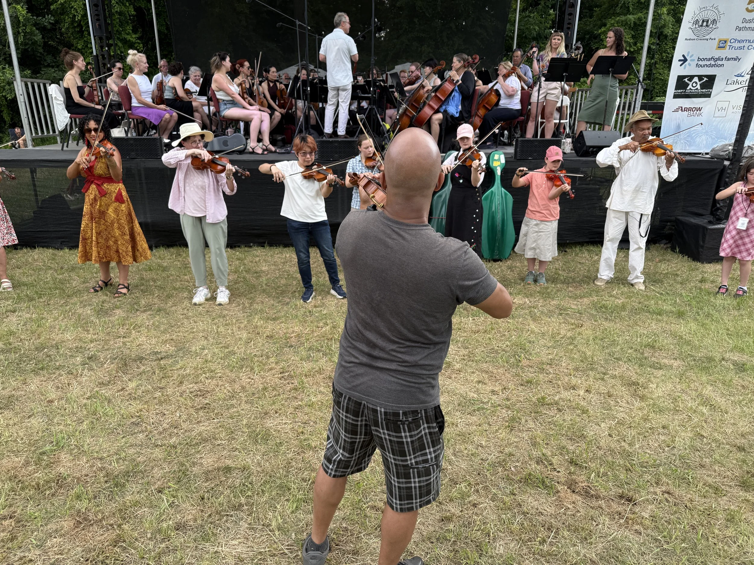 Composer Daniel Bernard Roumain, the Albany Symphony, and violin workshop participants rehearse Nightmares and Dreams for Solomon Northup in Schuylerville, NY on July 6, 2026