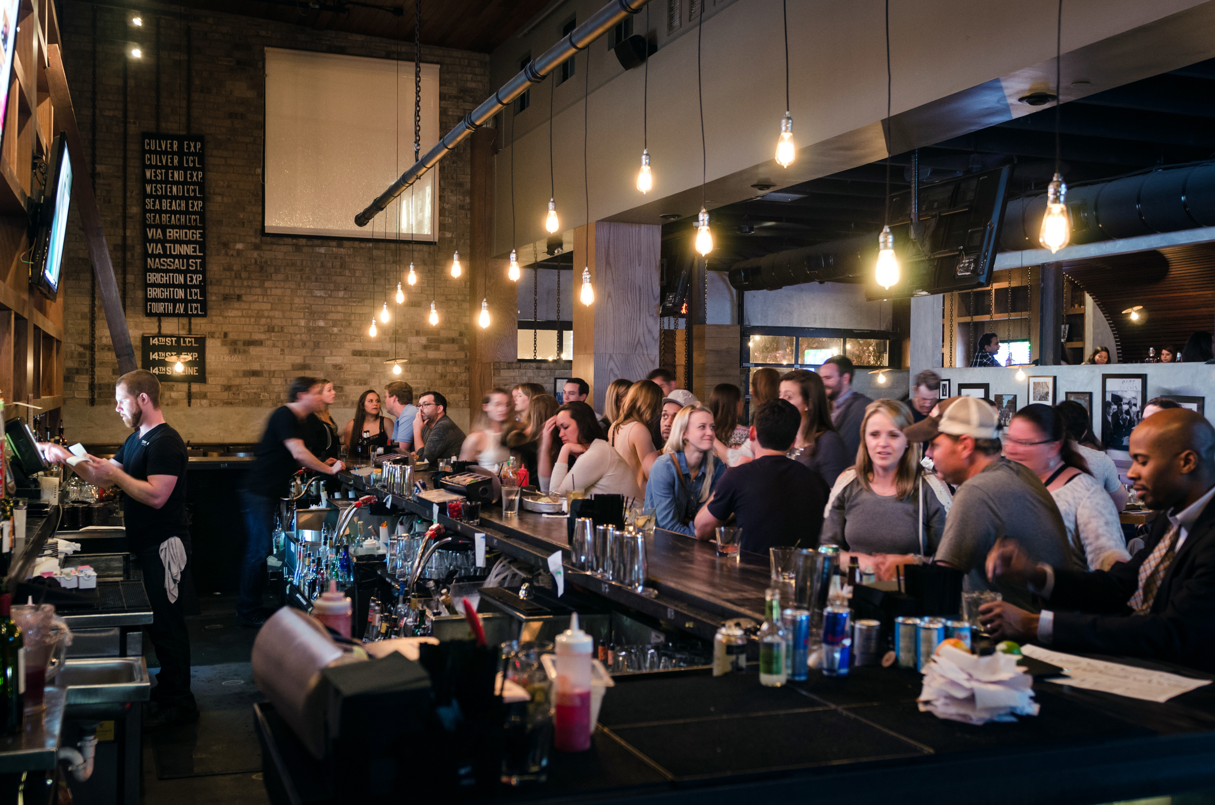 Friends gathered around the bar to celebrate Thirsty Thursday.