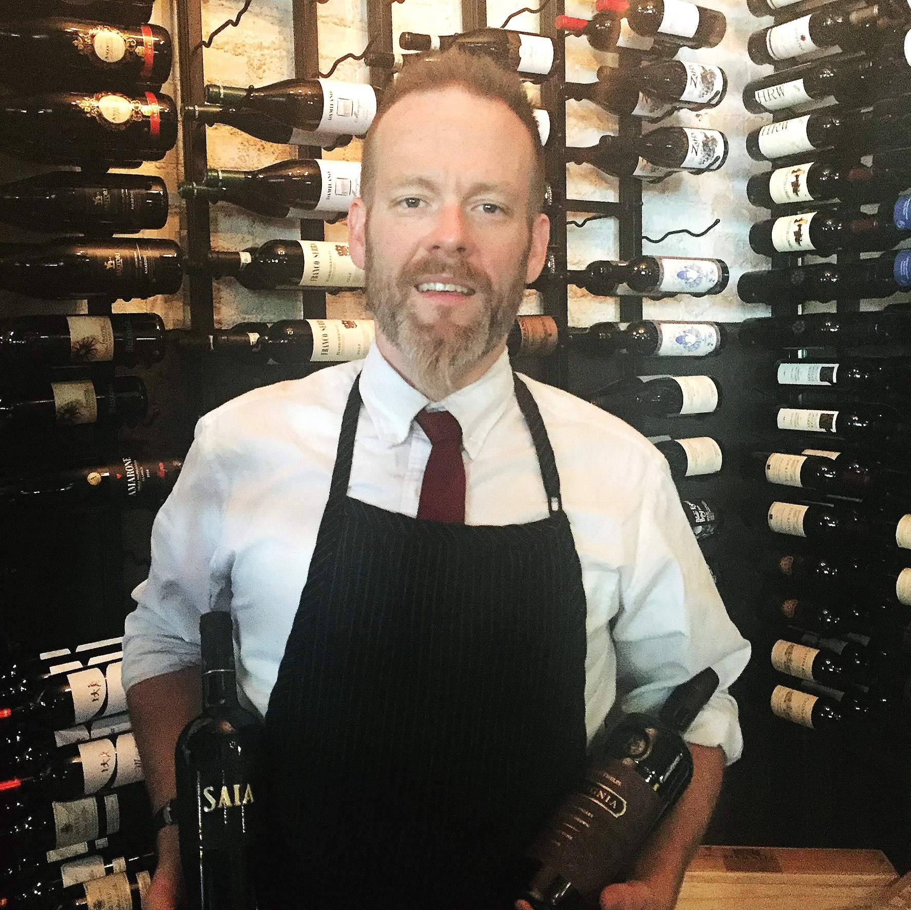 Matt displaying his two favorite wines, Joseph Phelps Insignia & Saia Nero d’Avola