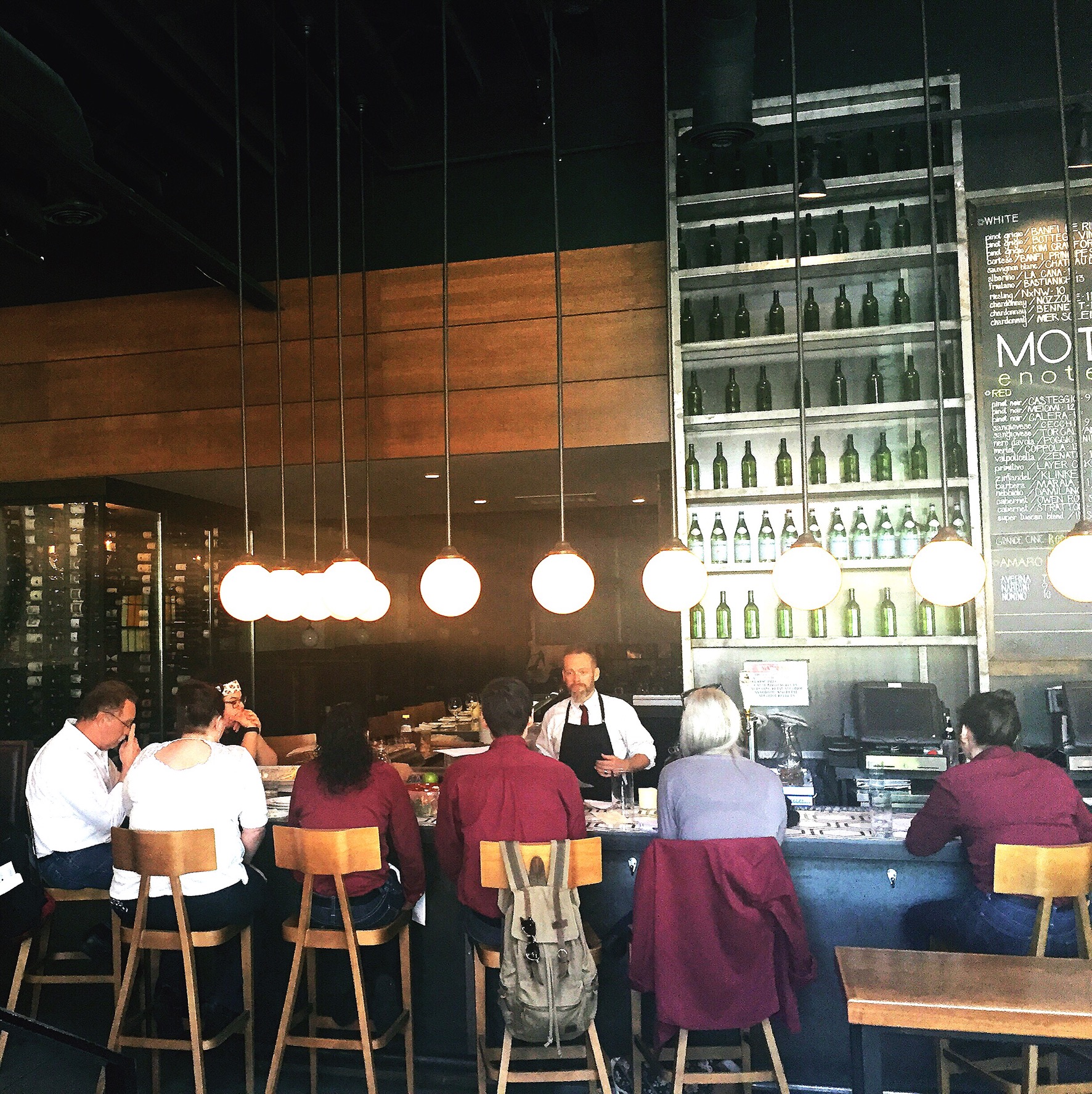 Matt leading a wine class at Moto's bar.