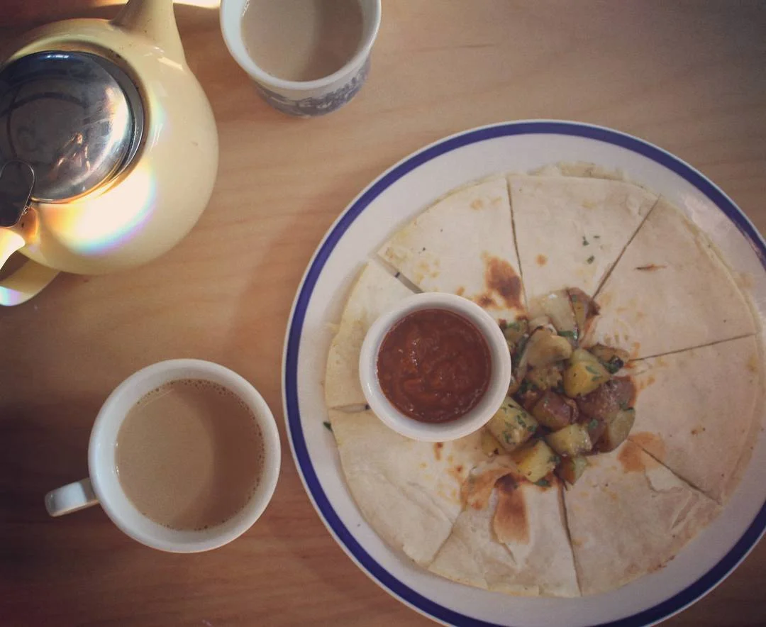 Breakfast Breakfast quesadilla, parmesan & cilantro, homemade fries, Shahiya red chutney, maple coffee & a little of sunshine