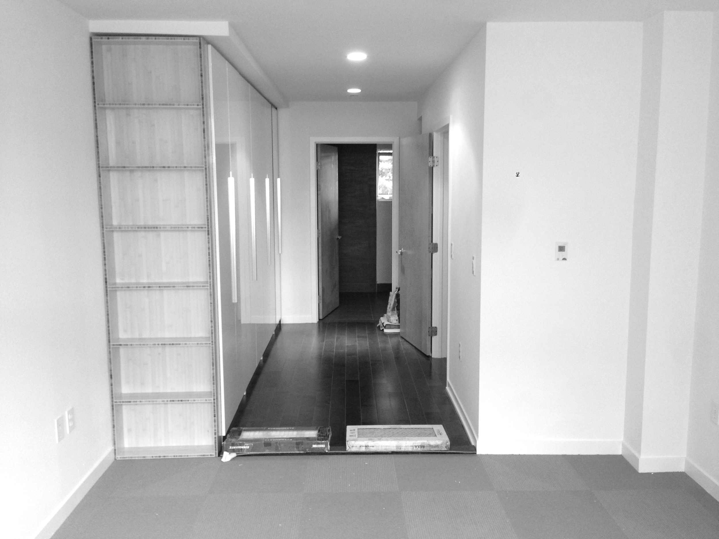 In this Dogpatch Condo remodel we maximized storage and created a visually clean impression with an IKEA closet system that was customized with an open bamboo shelf and white acrylic doors.