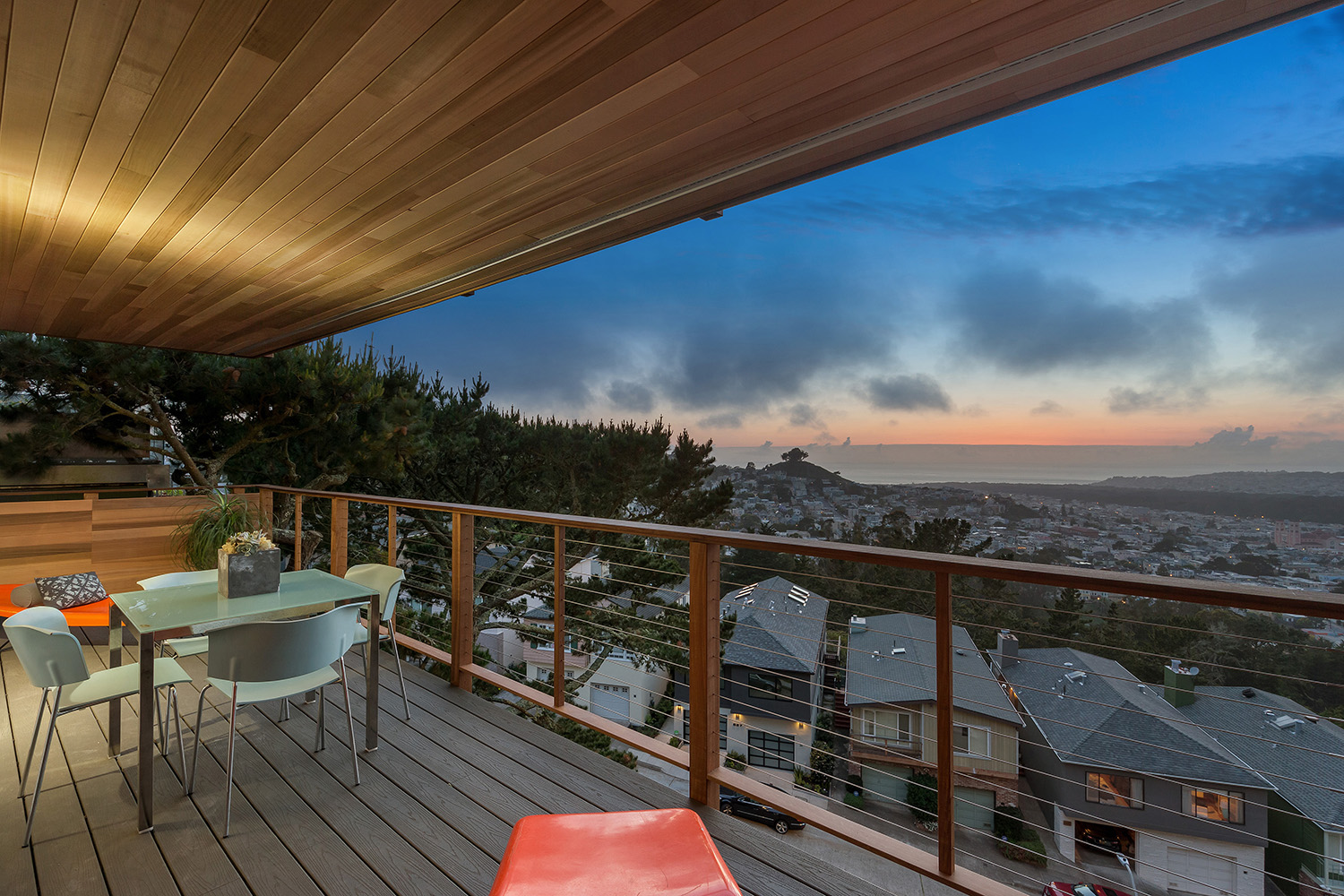 At the rear of the house, both the upper and lower levels are extended with full width decks. Ipe posts and rails are laced with stainless steel cable to maximize the view. Grey Trex deck boards complete the low maintenance composition.