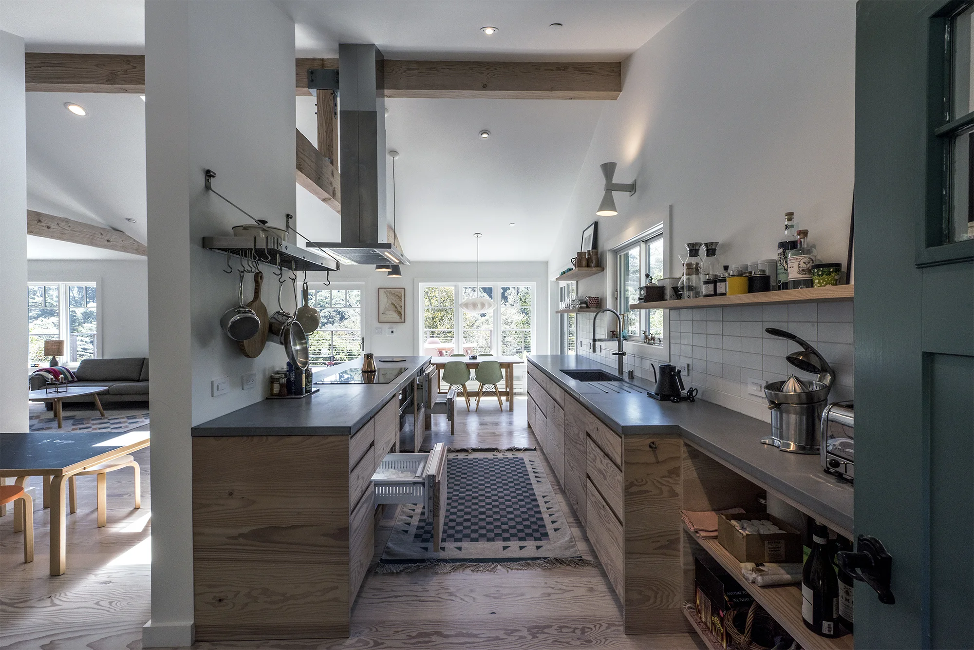 The refrigerator and freezer drawers are panel ready fitted with Douglas fir, from Sub-Zero. The induction cooktop and range from Wolf. Photography by Robert Cardin