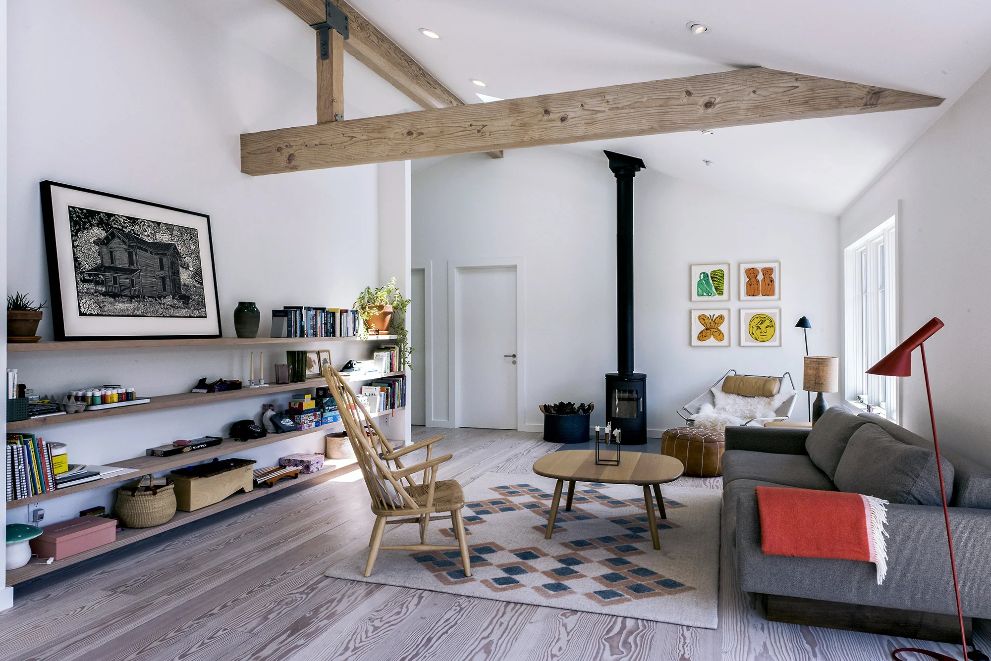 The living room is highlighted with Douglas fir cantilevered shelves and a flush concrete pad for the Morso wood-burning fireplace made in Denmark. Photography by Robert Cardin