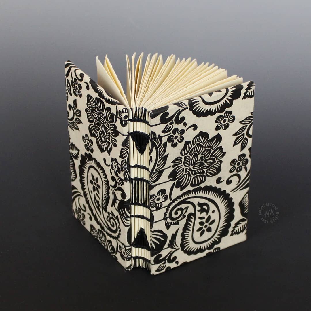 It's intensely satisfying when the cover and spine come together so cohesively.  This book delivers a tropical feel with a black and white woodcut style printed cover paper.  It is bold and noticable without being too busy.

The book shown here is cu