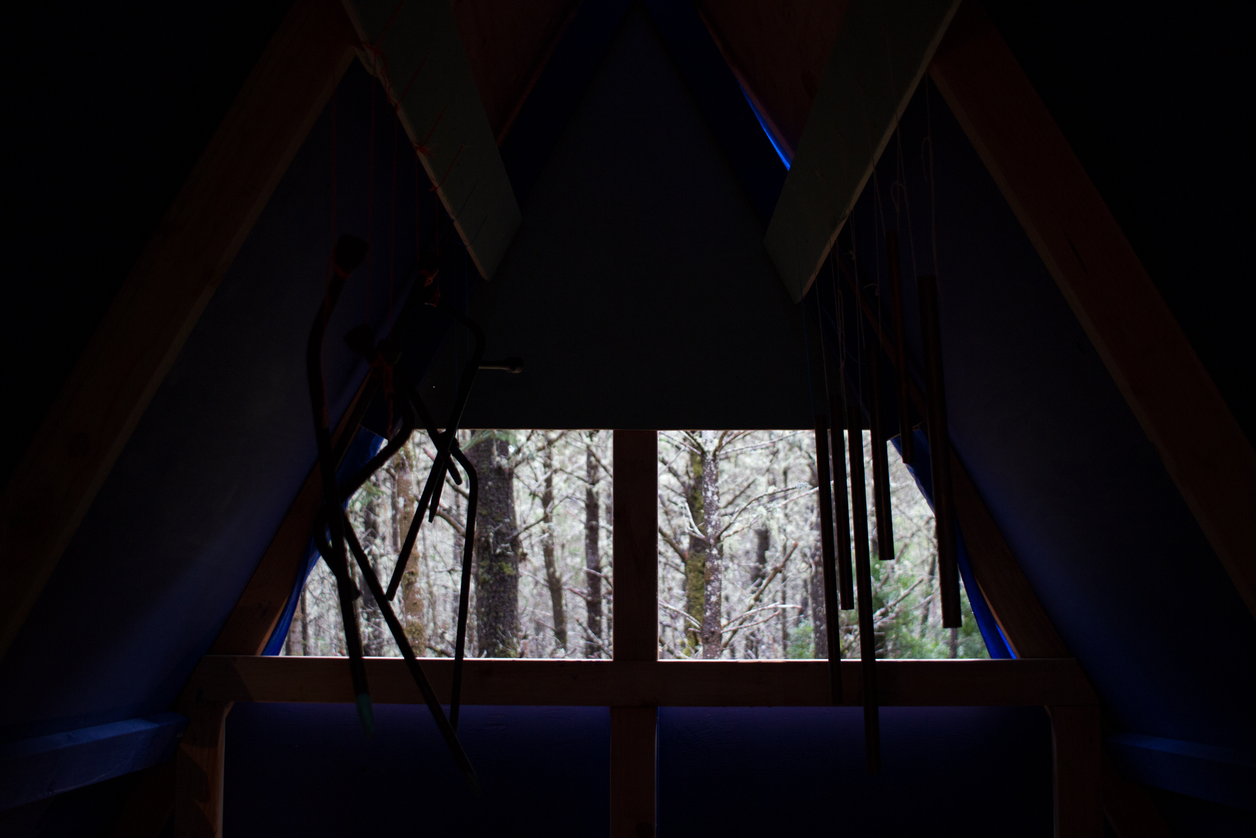  Interior with chimes and framed view out of back window. 