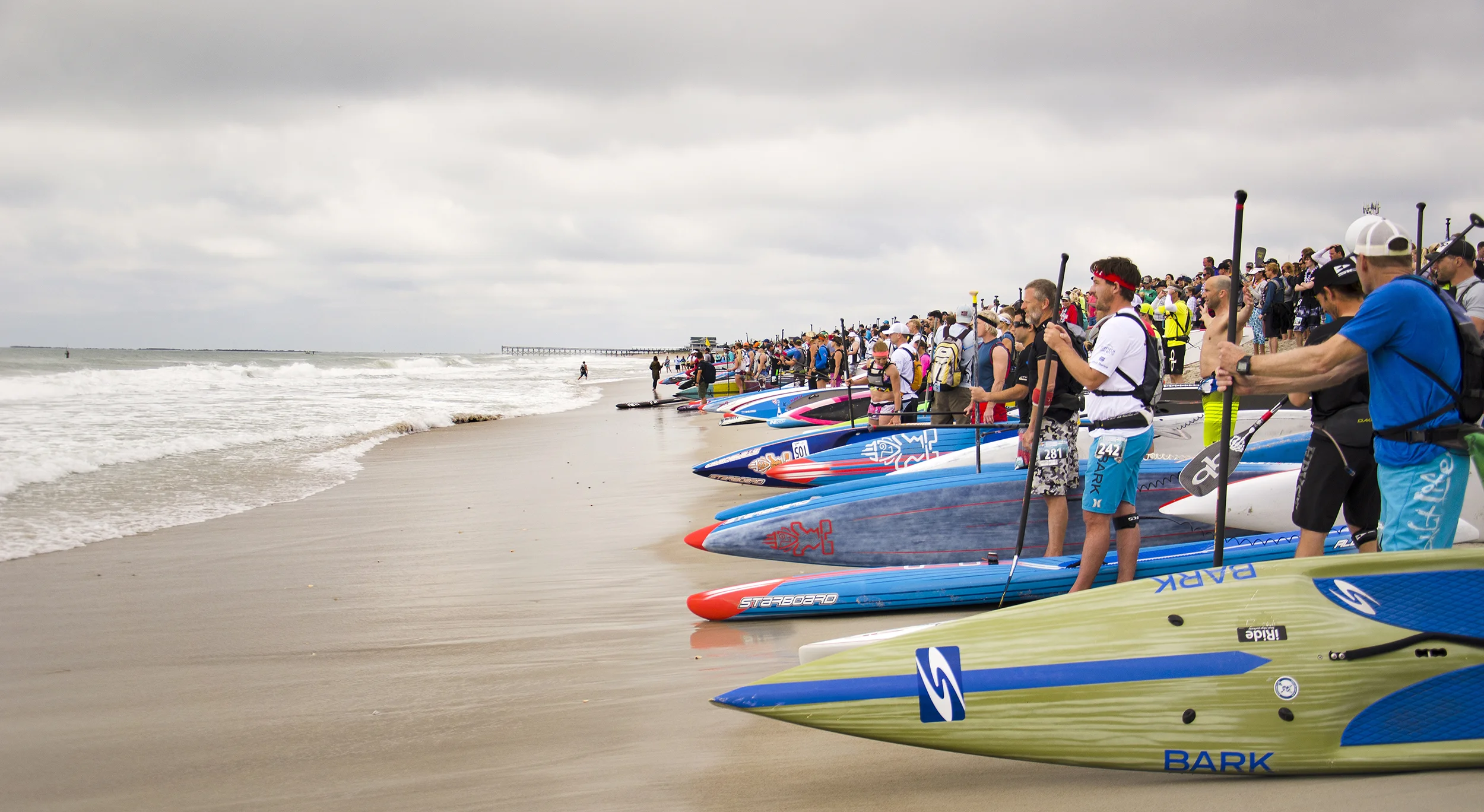 Competitors for the elite, Graveyard Race, stare down the grey sky and choppy surf.