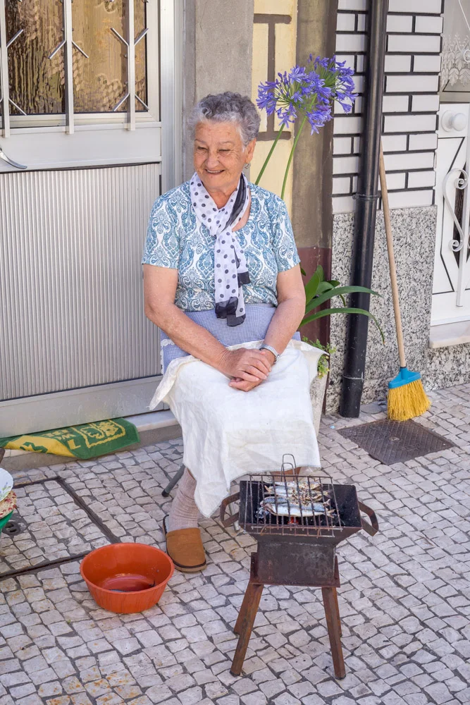 Granny making herself some grilled sardines for lunch.