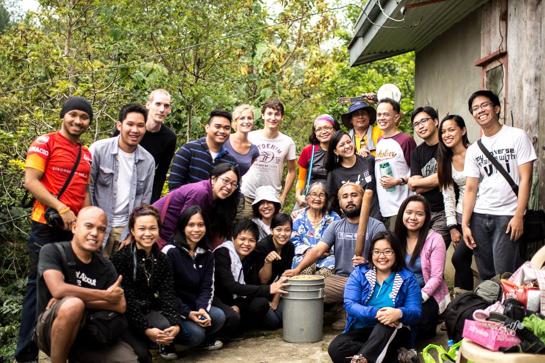 Coffee AID volunteers taking a break from harvest duties at Nana Meldina Calubsing's farm. She's the cheerful lady, seated in the centre.