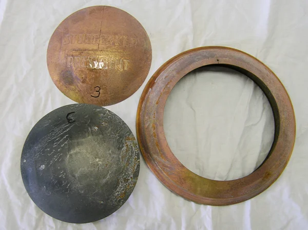 Brass plate, steel backing plate, and remnant of hub cap. 