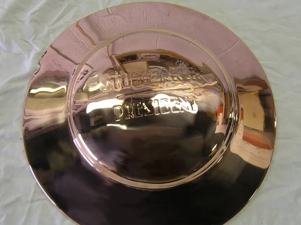 Several coats of copper are applied, each one being sanded and buffed, until a bright finish is obtained. 