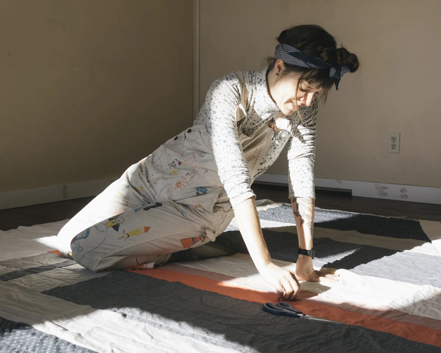 Zena Verda Pesta working on one of three quilts she created for The Jennings