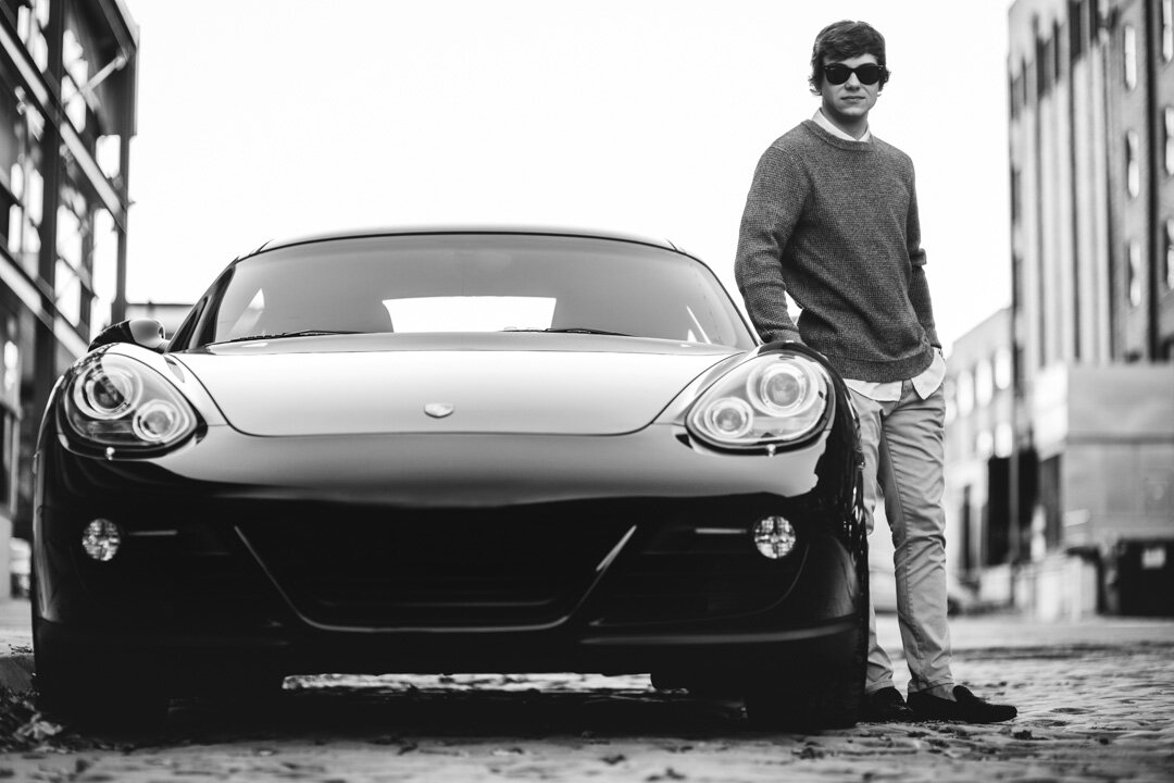 Portrait of high school student next to Porsche