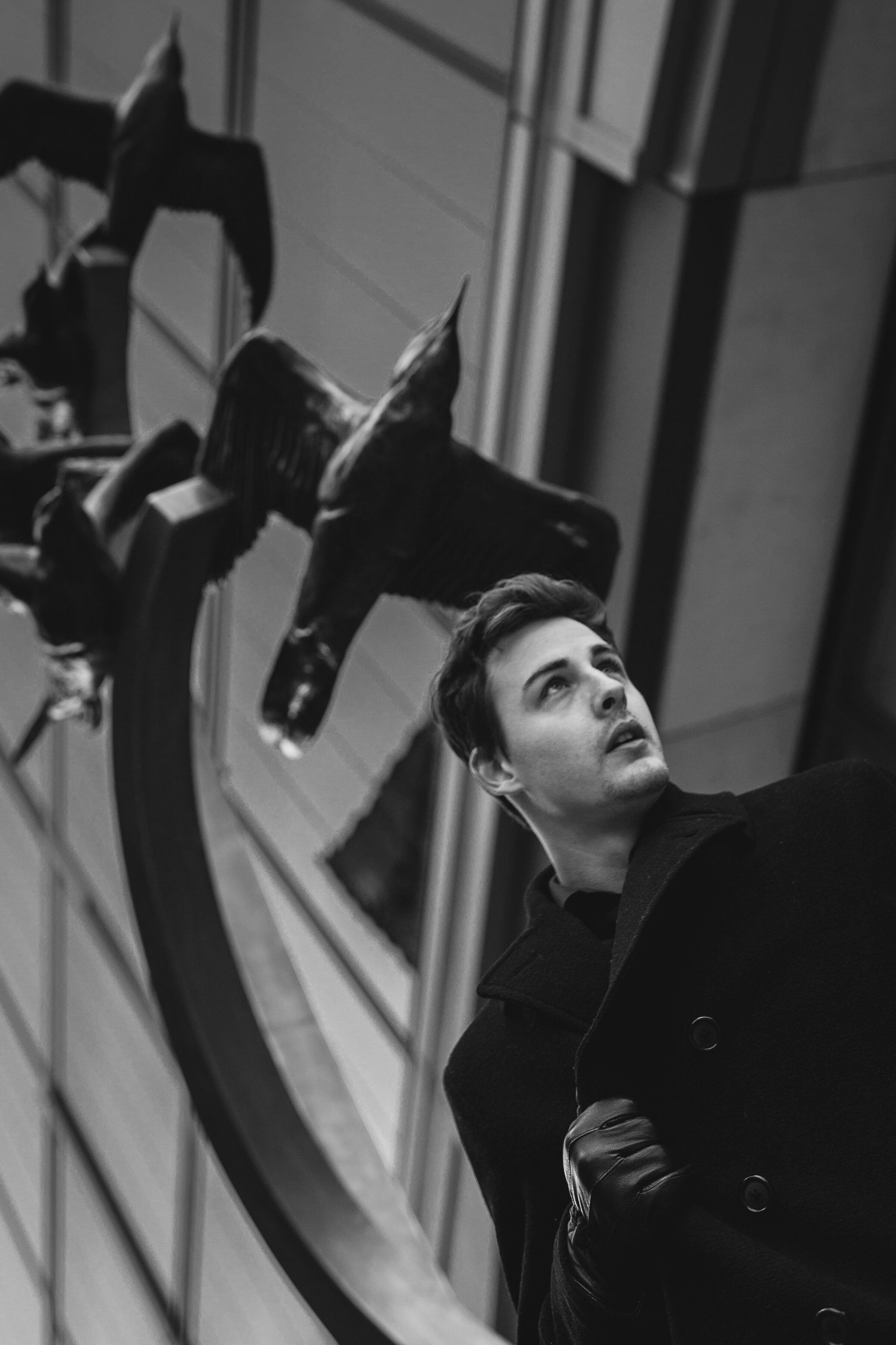 Sculpture of birds and high school senior in black and white