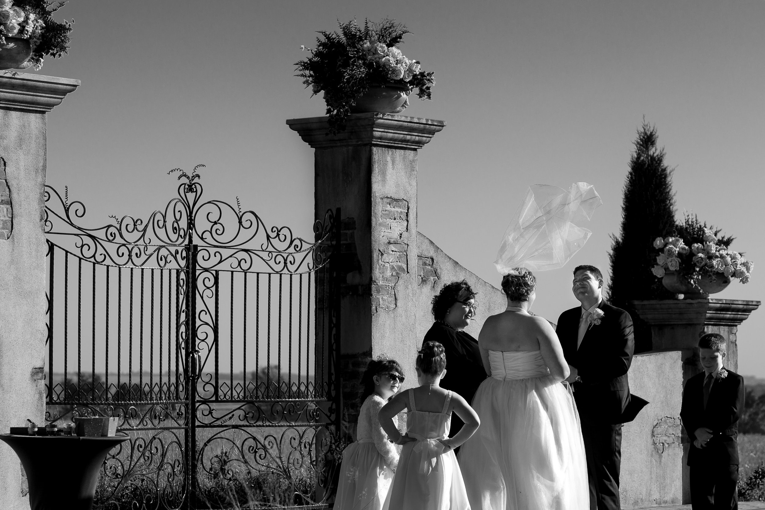  I thought this was funny, the wind kept blowing Jaymes’ veil around for a bit, then this little gust comes and blows her veil straight up, the look on Justins face is great, all while the girls are having their own conversation. 