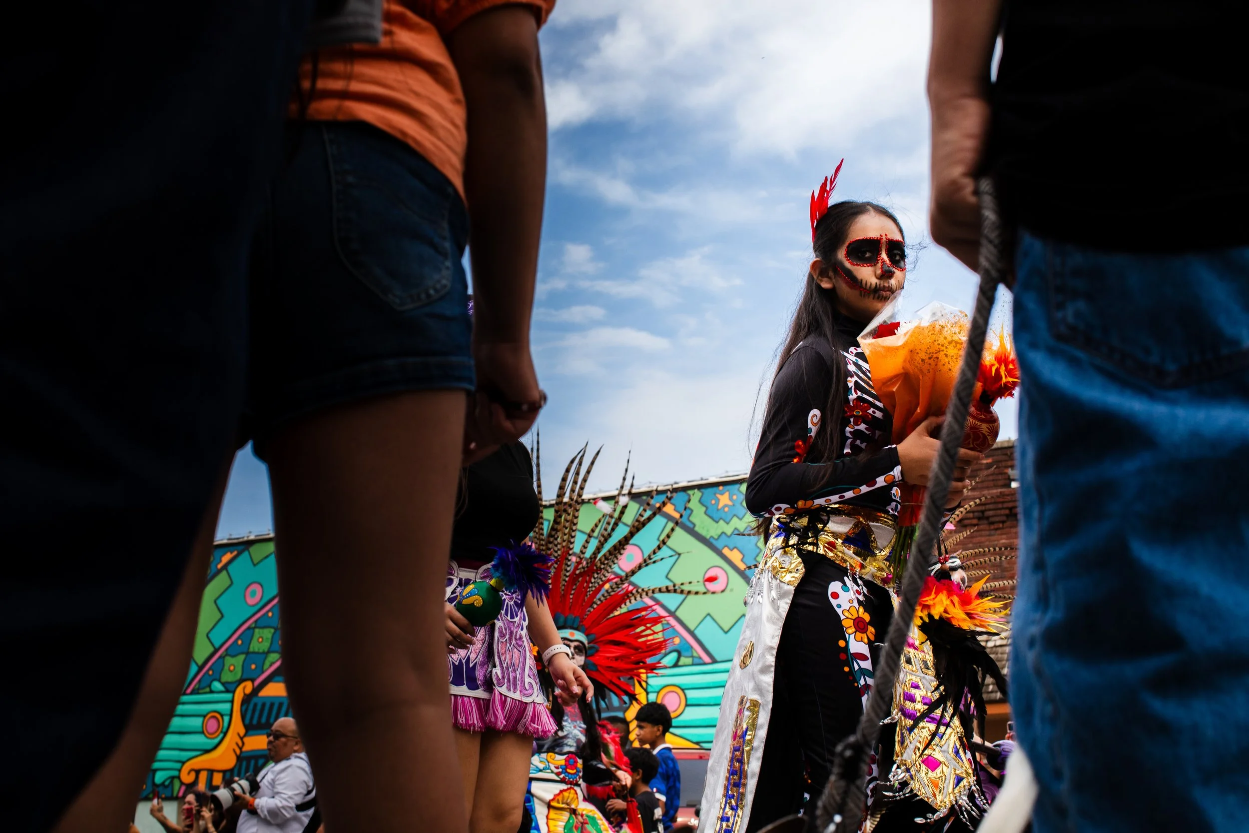  A young girl in La Catrina face paint and dress walking in the dia de los muertos parade in historic South Omaha. 