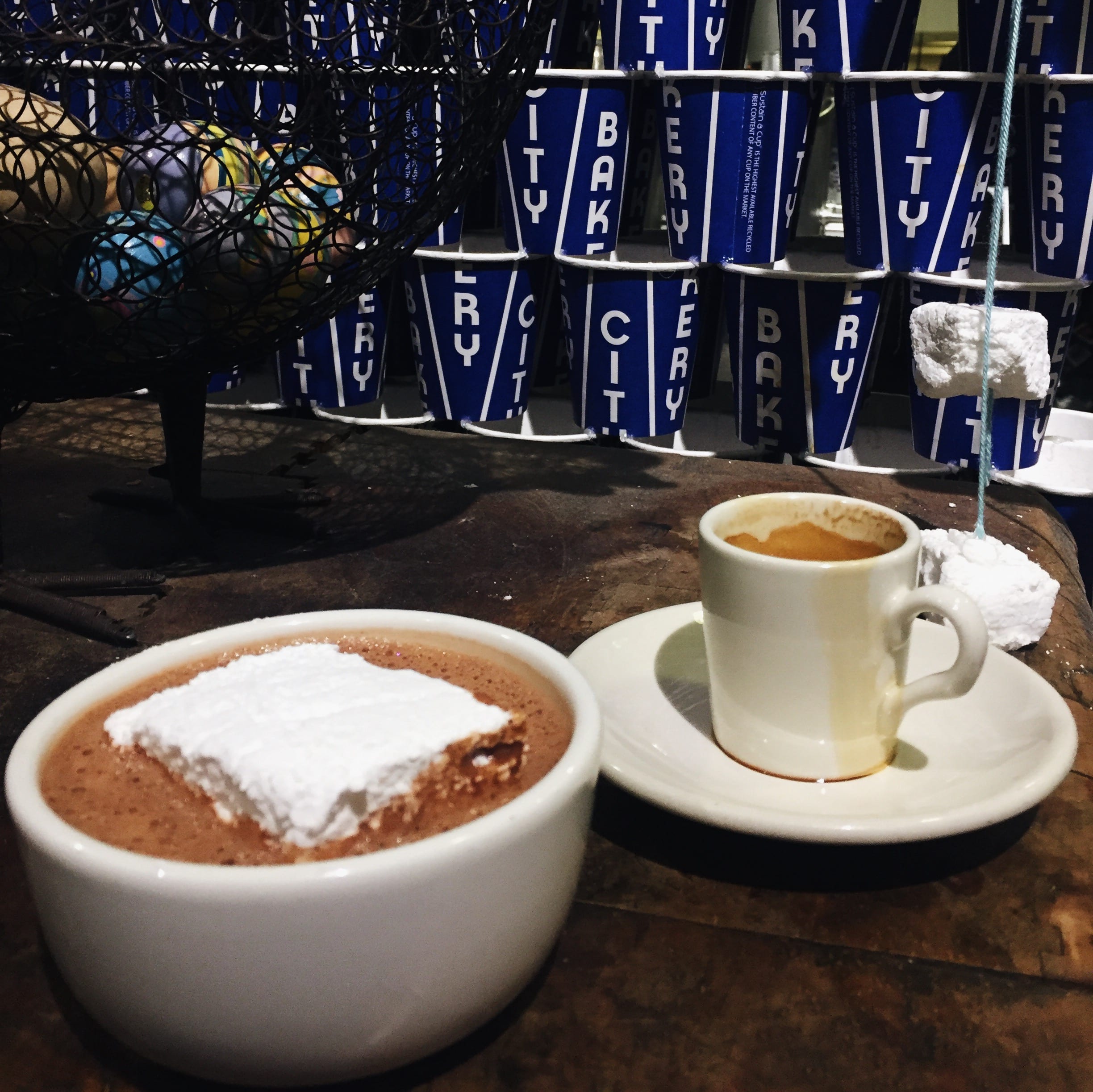 Hot chocolate and espresso at City Bakery for coffee date in mugs.