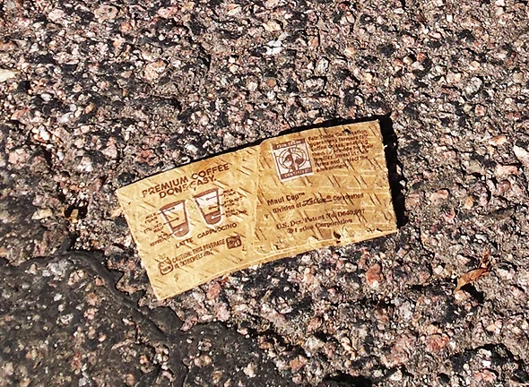 Cardboard sleeves now litter the landscape across the United States because people have found it more convenient to drop them on the pavement than to recycle them in order to reduce waste.