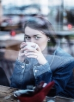 Teenager drinking coffee in coffee shop.jpeg