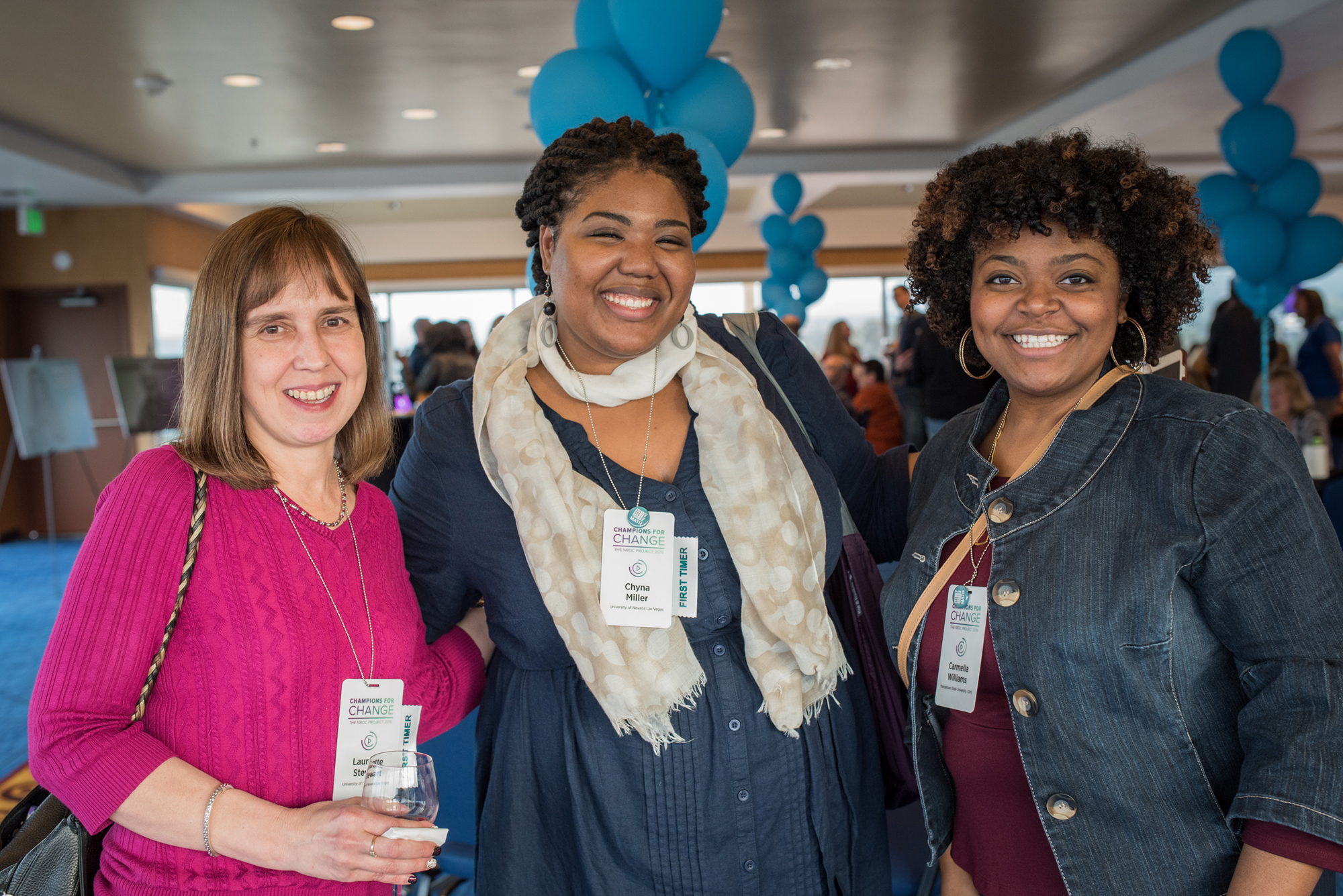 meeting participants (showing name tags, buttons, posters in background)