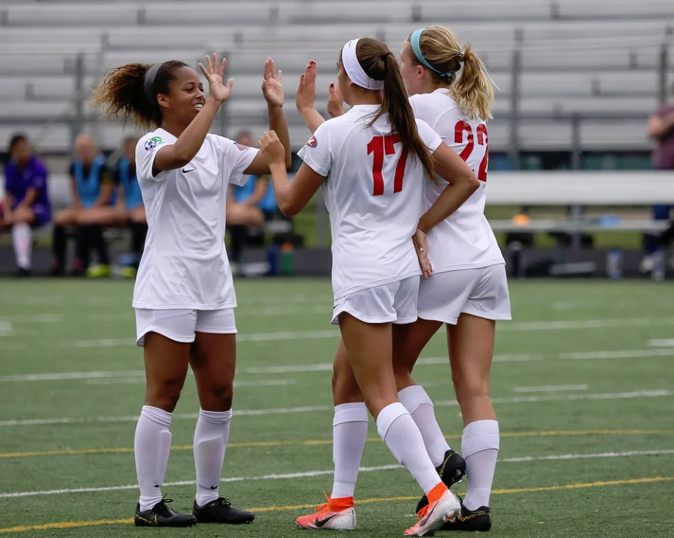 Courtney Jones (left), Mariana Speckmaier (17) and Taylor Timko (22) celebrate MCFC’s second goal in their 3-1 decision over the Columbus Eagles. (JDN2 Photography)