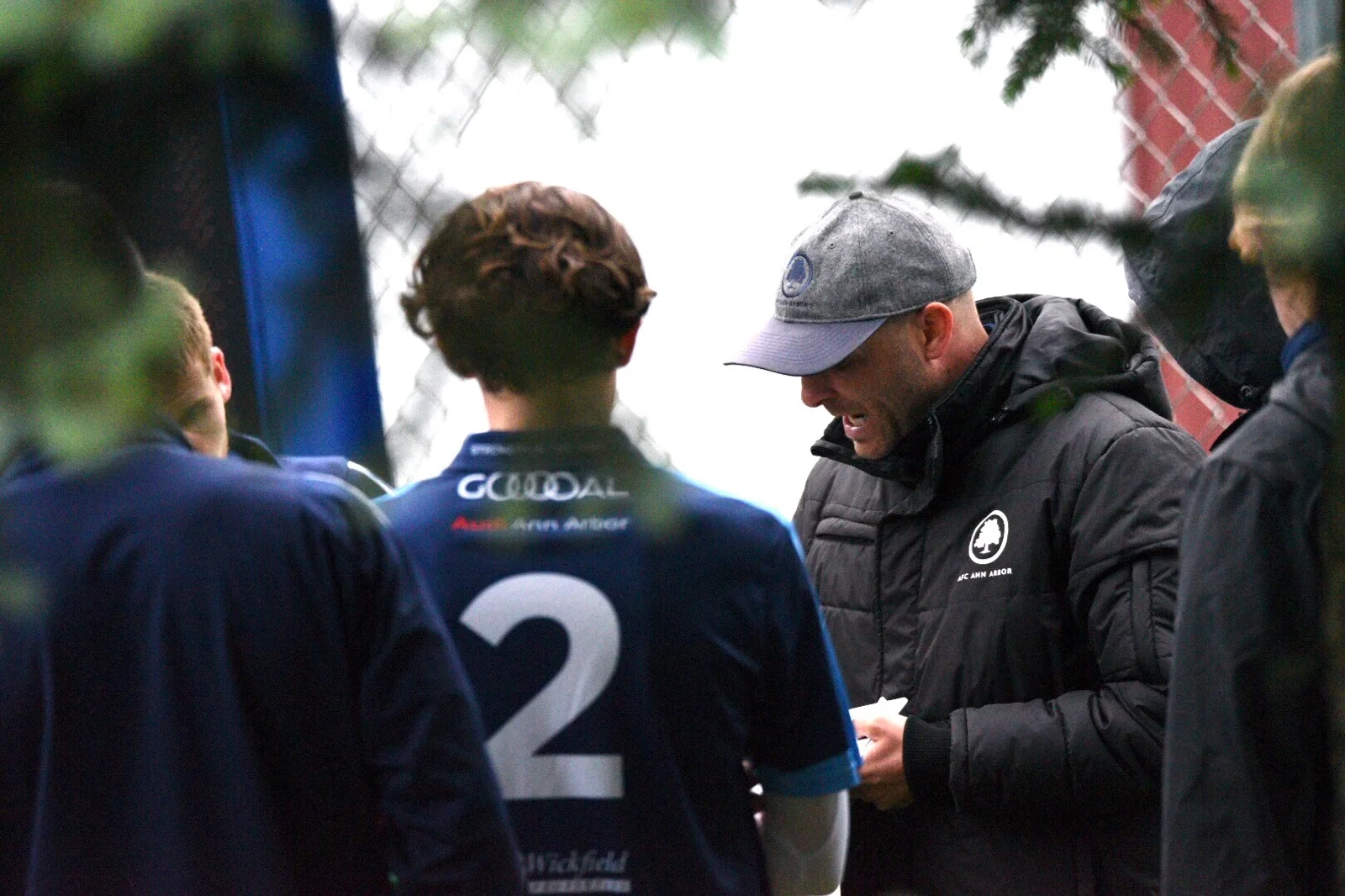 Coach Rudland talks to his team at half on Friday evening at Mayor's Riverfront Park