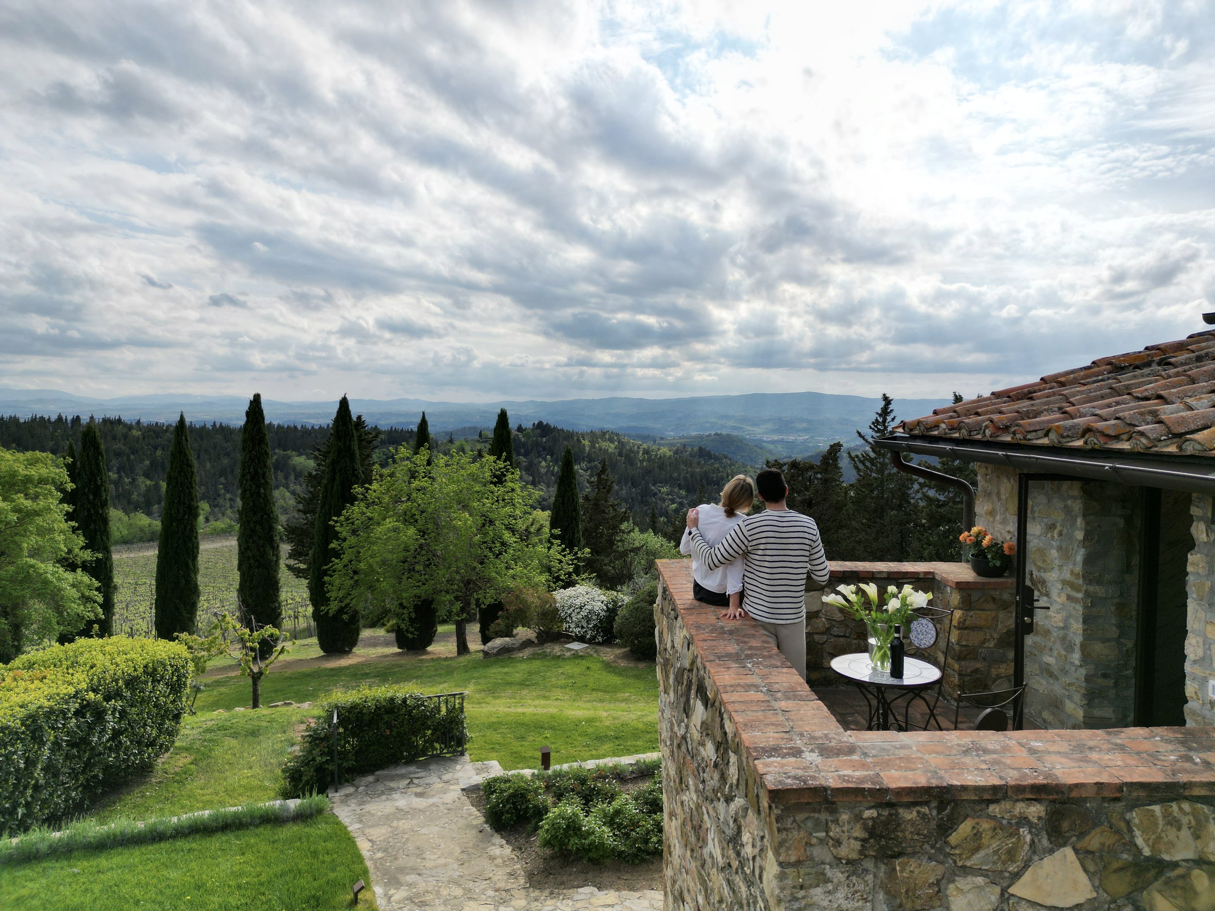 Bedroom #4 - exterior balcony drone with couple (view of Tuscan landscape).JPG