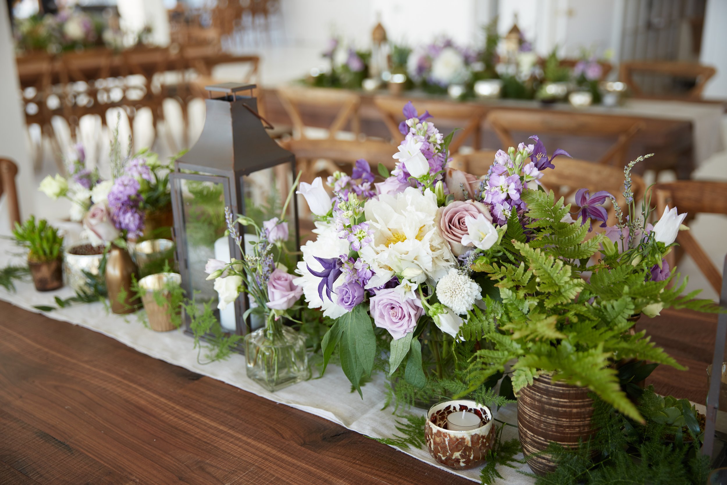 rectangle table collection centerpiece white lavender roses lisianthus succulents campanula scabiosa moroccan pewter copper lanterns studio 450 11.jpg
