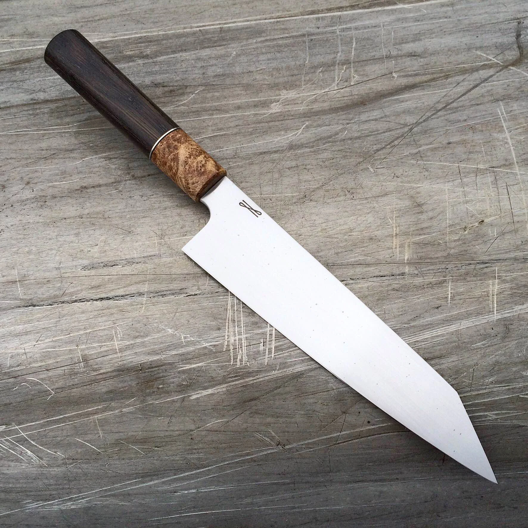 8" K-tip gyuto, 52100 steel, stabilized ancient bog oak, stabilized maple burl, black and nickel-silver spacers, oval handle.