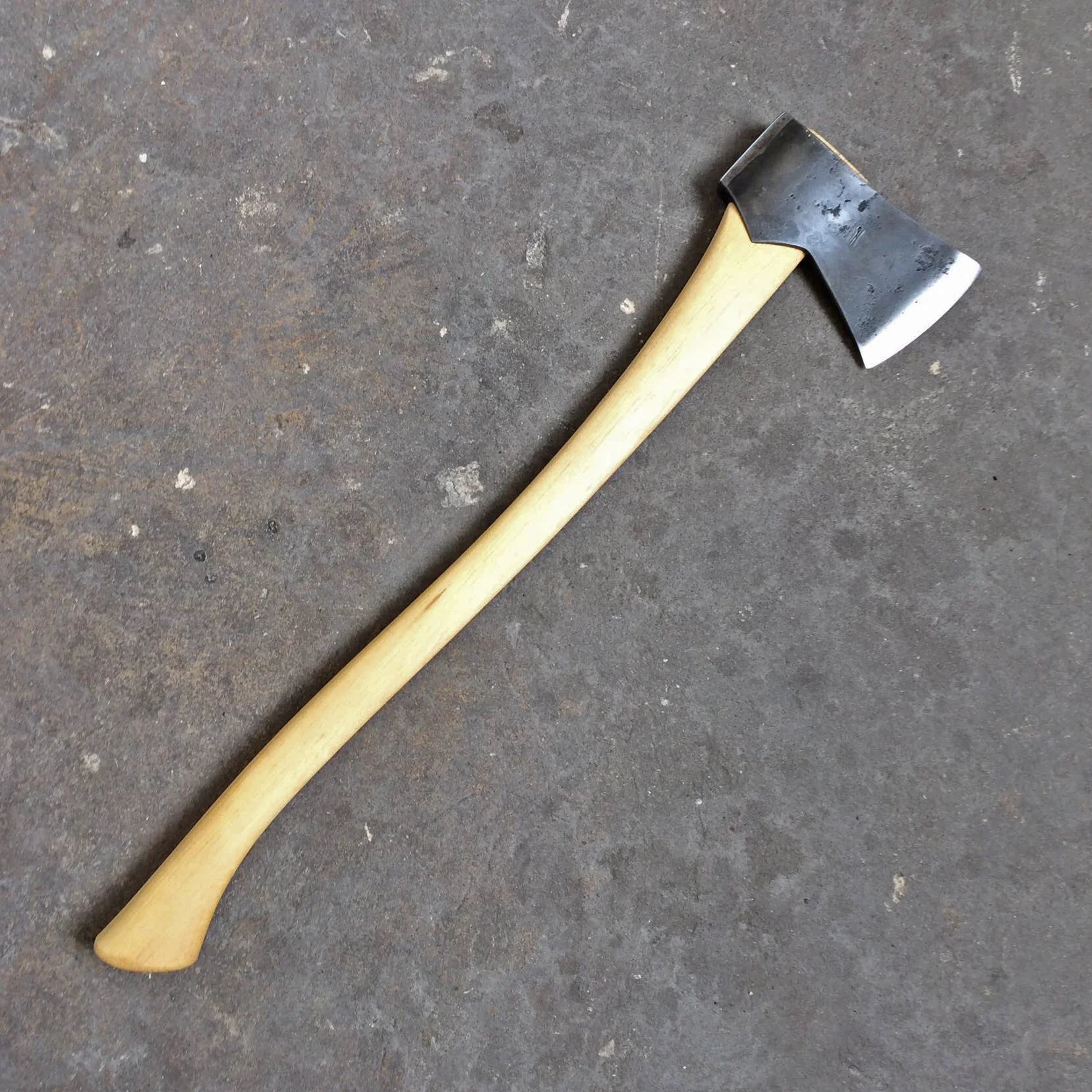 Camp Axe, 1075 carbon steel bit and poll, forge welded to 1018 mild steel, head weighs about 2 lbs. 25" hand-carved hickory handle. 