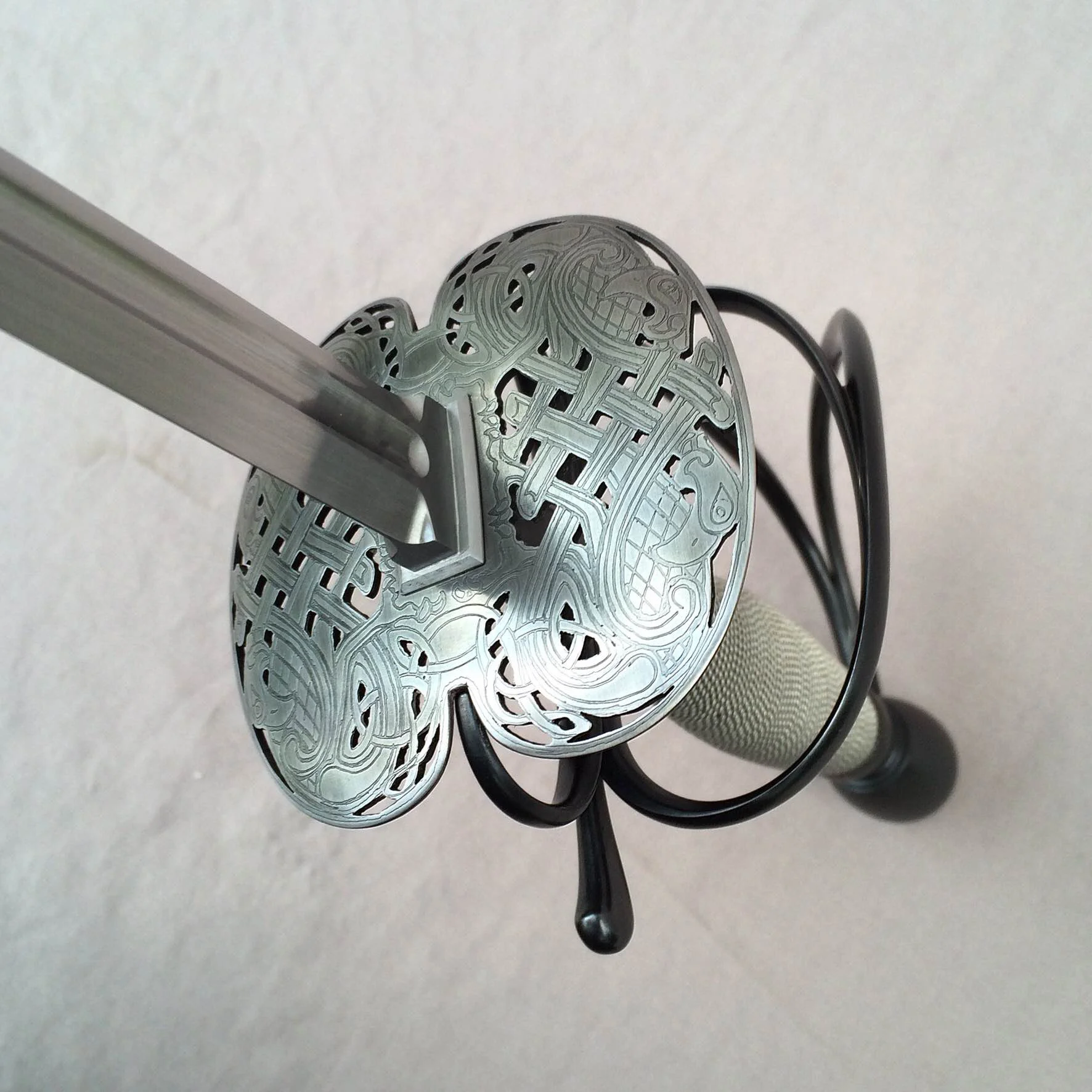 Detail of blade geometry, pierced and etched shells, quillon, loop and knuckle bow.