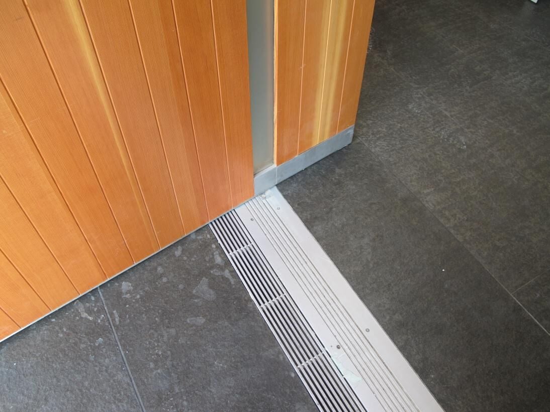 Custom aluminum threshold, wood pivot door