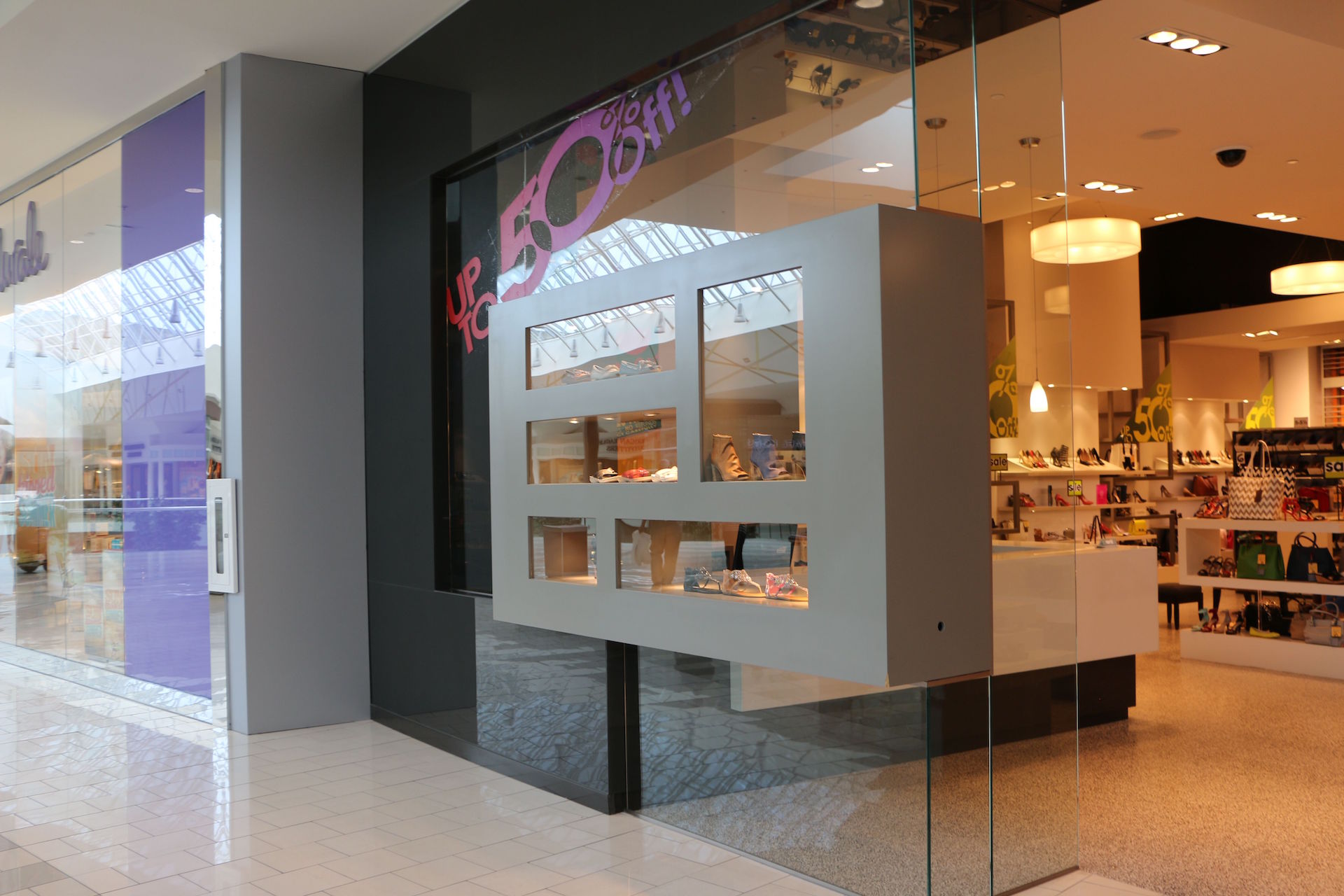 Custom storefront including back-painted glass wall cladding