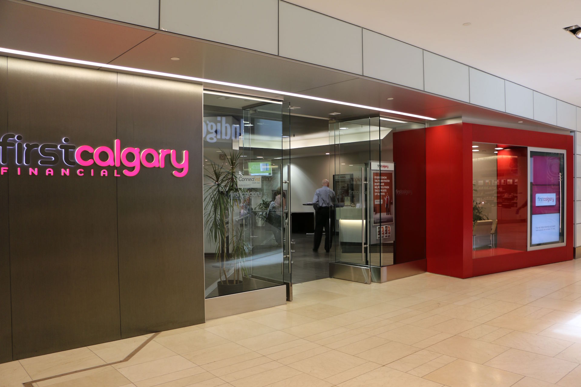 Custom storefront including back-painted glass wall cladding, clear glass and doors