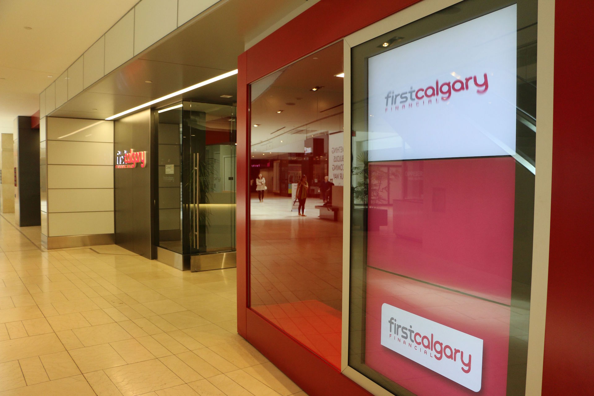 Custom storefront including back-painted glass wall cladding, clear glass and doors