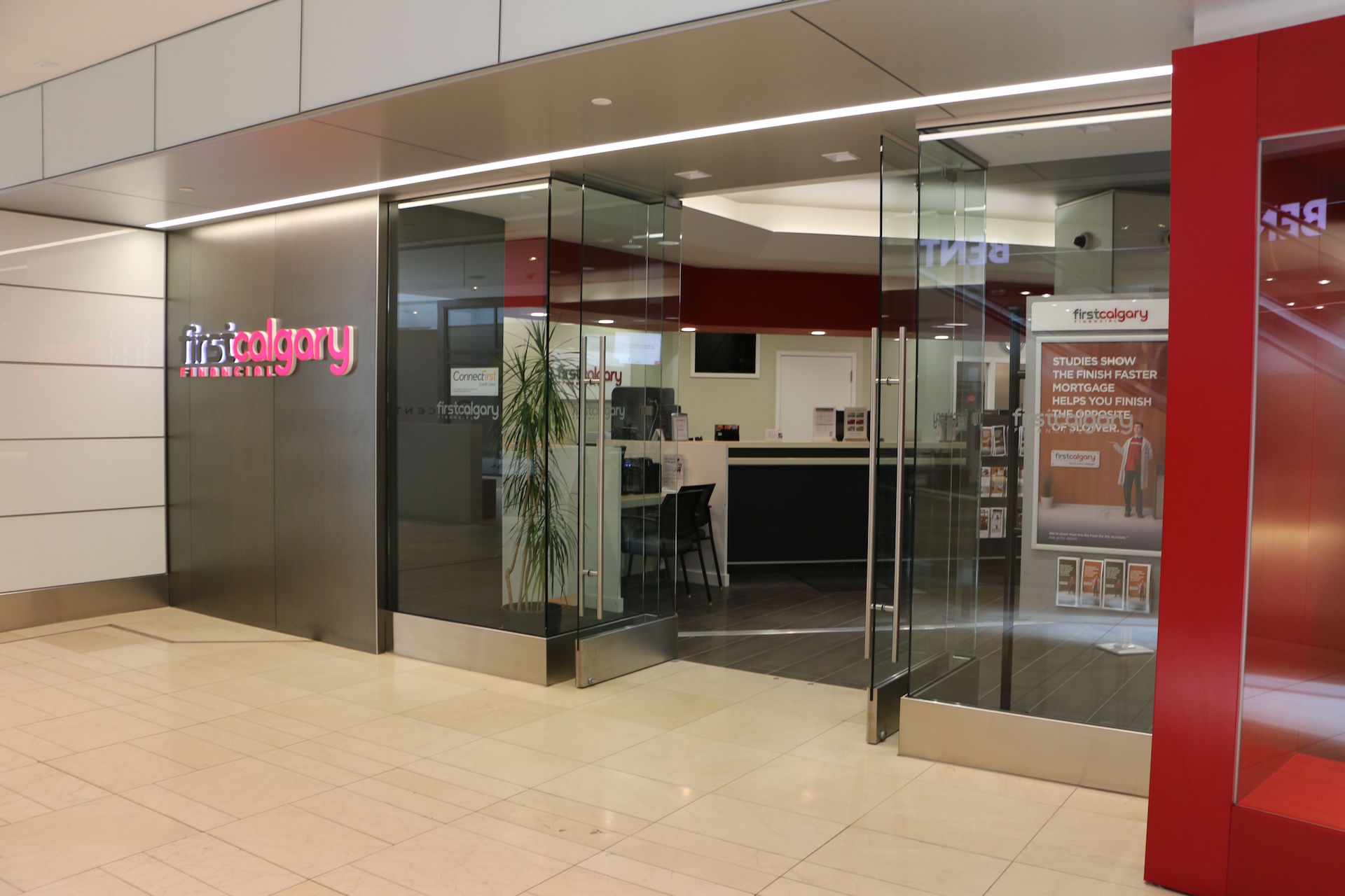 Custom storefront including back-painted glass wall cladding, clear glass and doors
