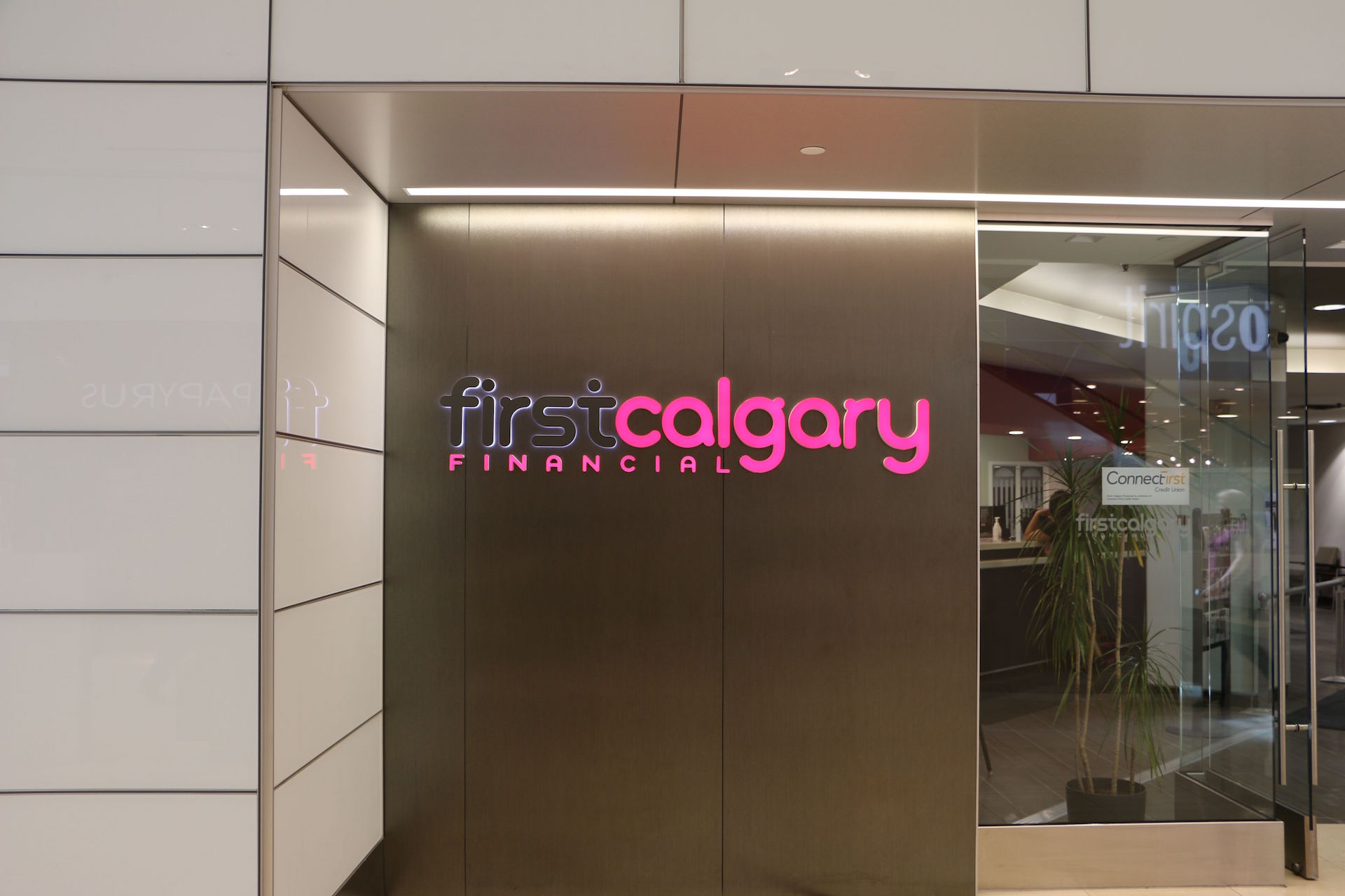 Custom storefront including back-painted glass wall cladding, clear glass and doors