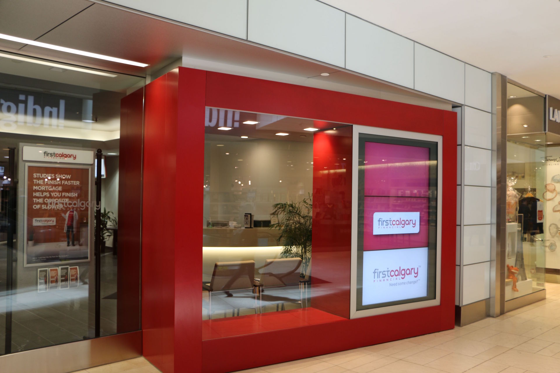 Custom storefront including back-painted glass wall cladding and clear glass