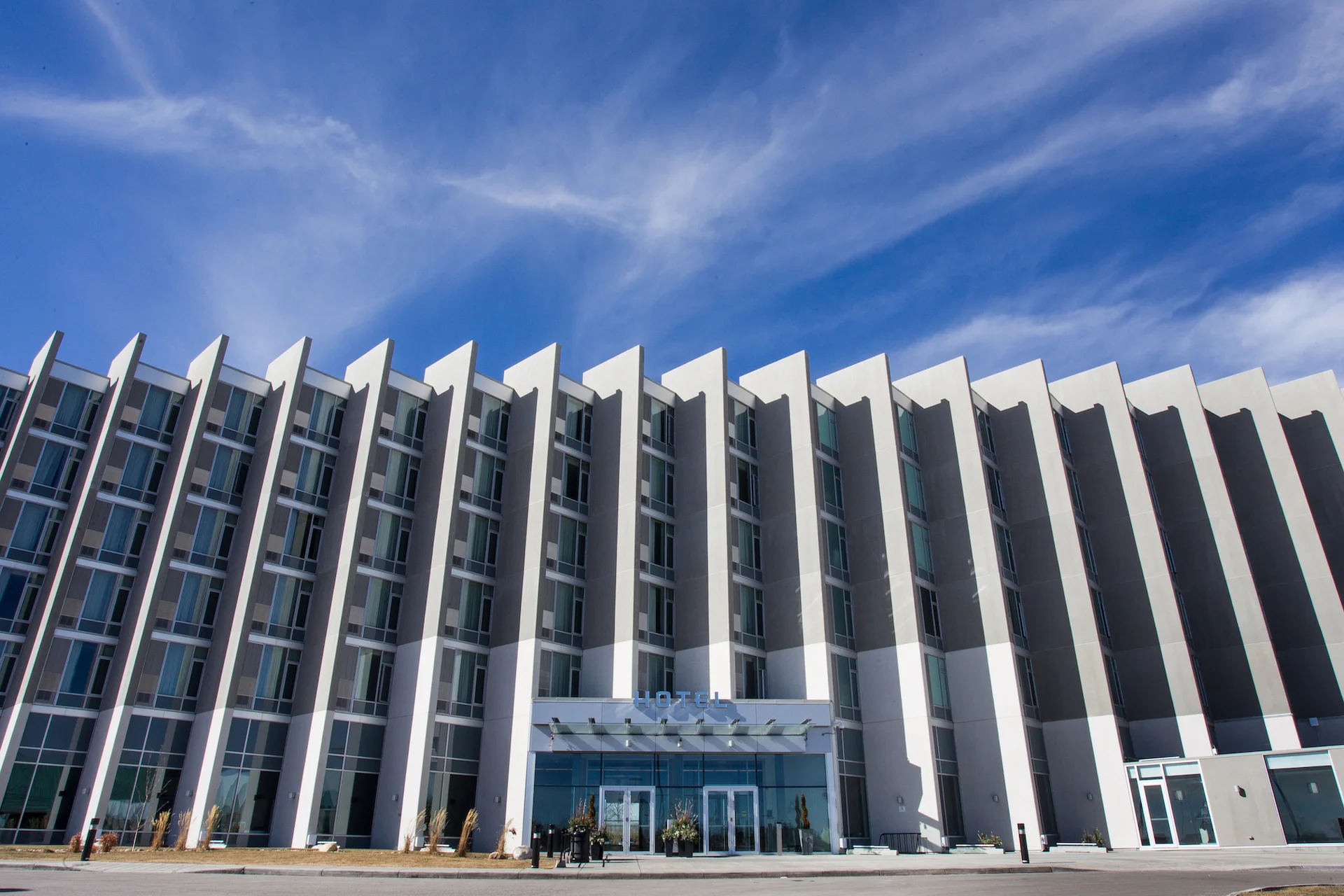 Alumicor 2500 series curtainwall with SSG, 970 series windows, aluminum panels, Alumicor doors, glass canopy