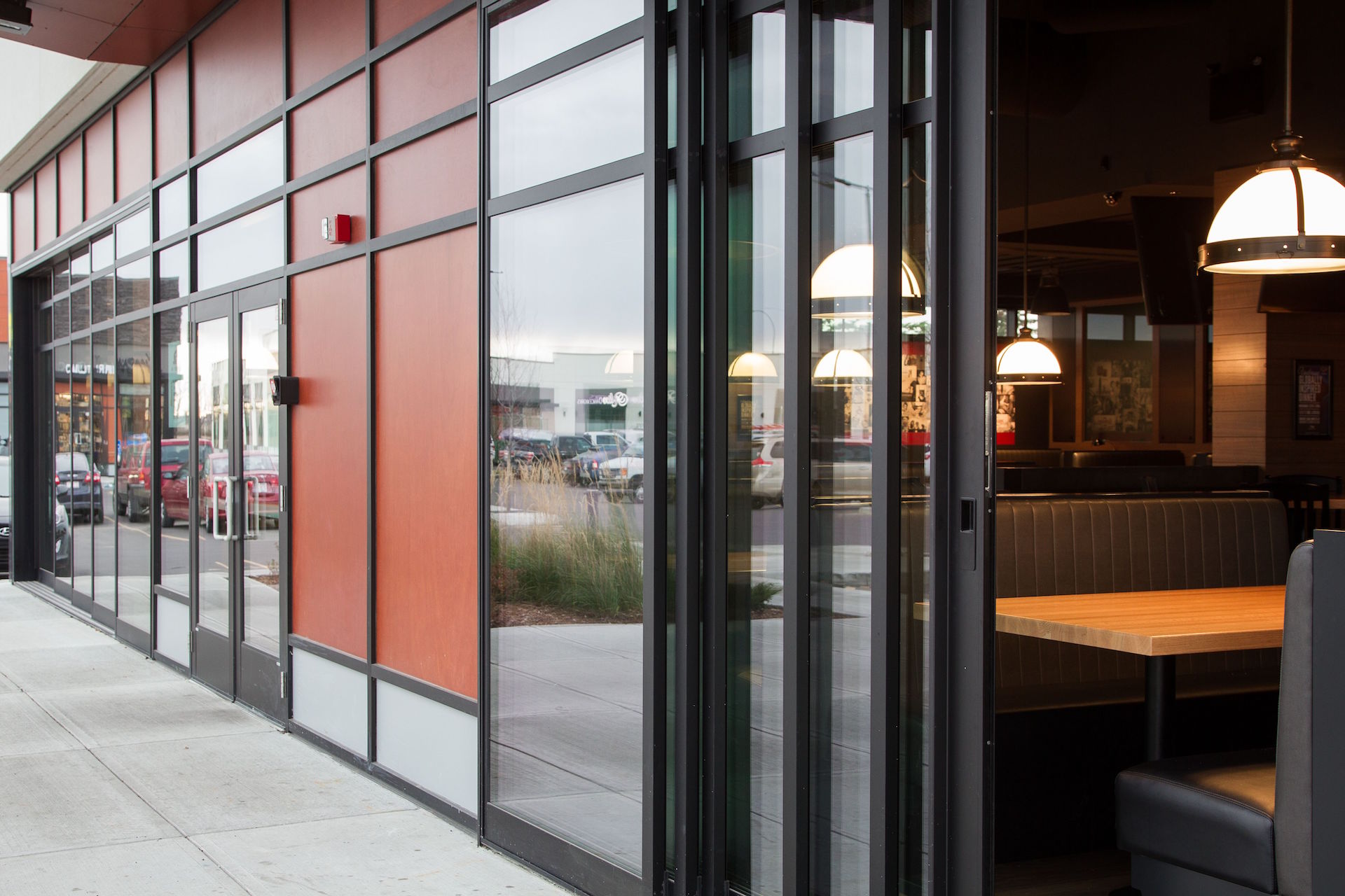 Alumicor 2500 series curtainwall and doors, Prodema spandrel panels, Fleetwood 3070CR custom multi-slide doors