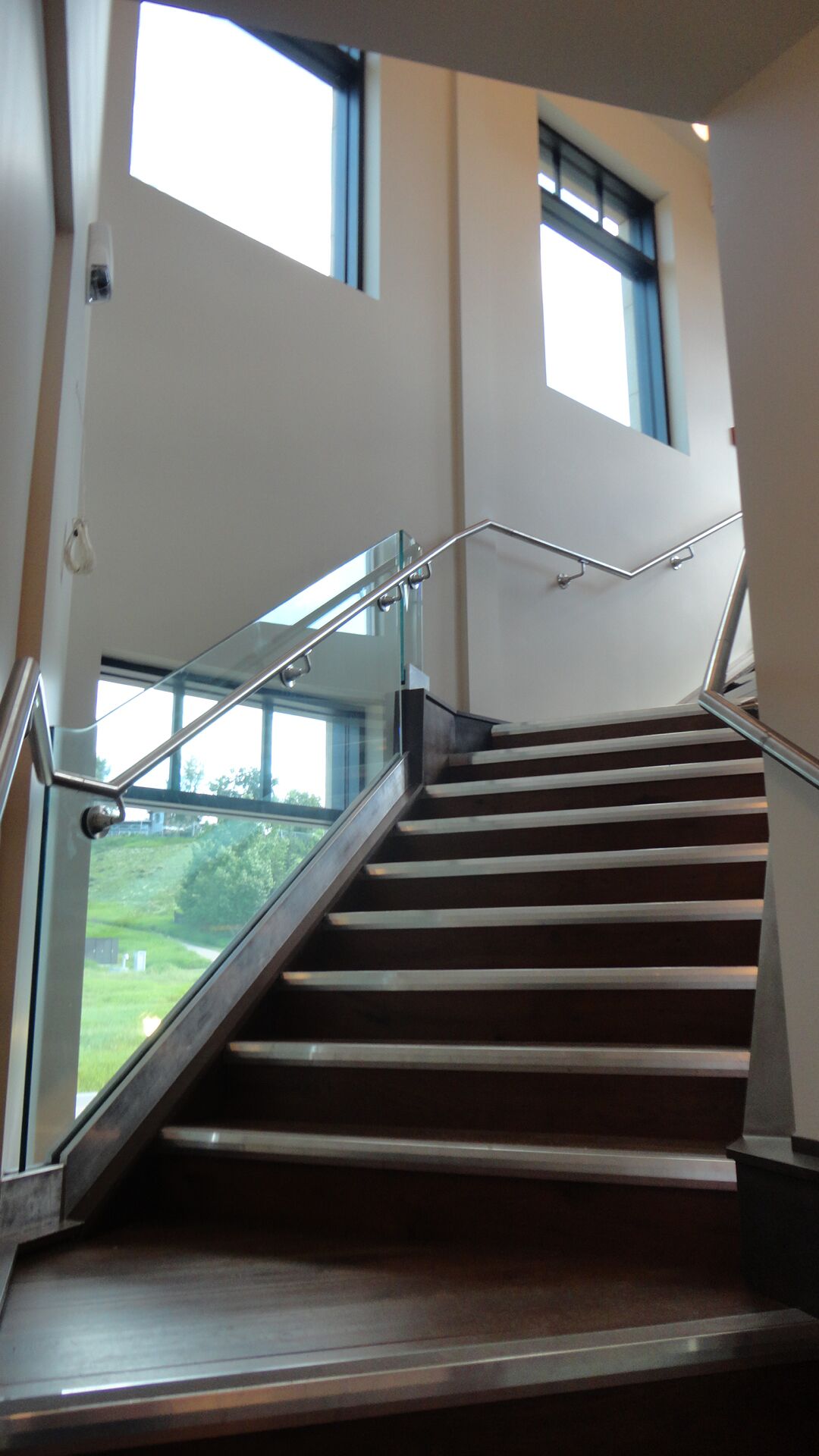 Alumicor 2200 series windows with 3-1/4" deep cap, stainless steel handrail, interior glass guardrail