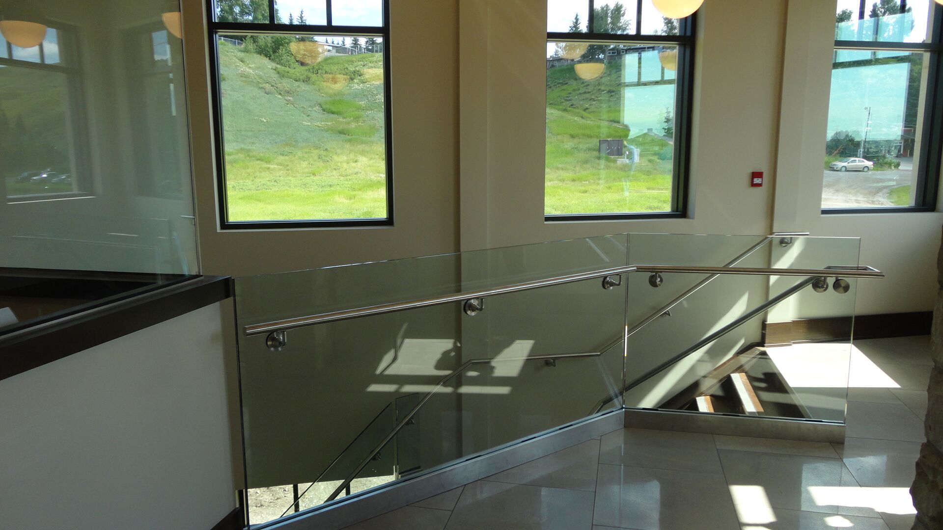 Alumicor 2200 series windows with 3-1/4" deep cap, stainless steel handrail, interior glass guardrail, interior windows