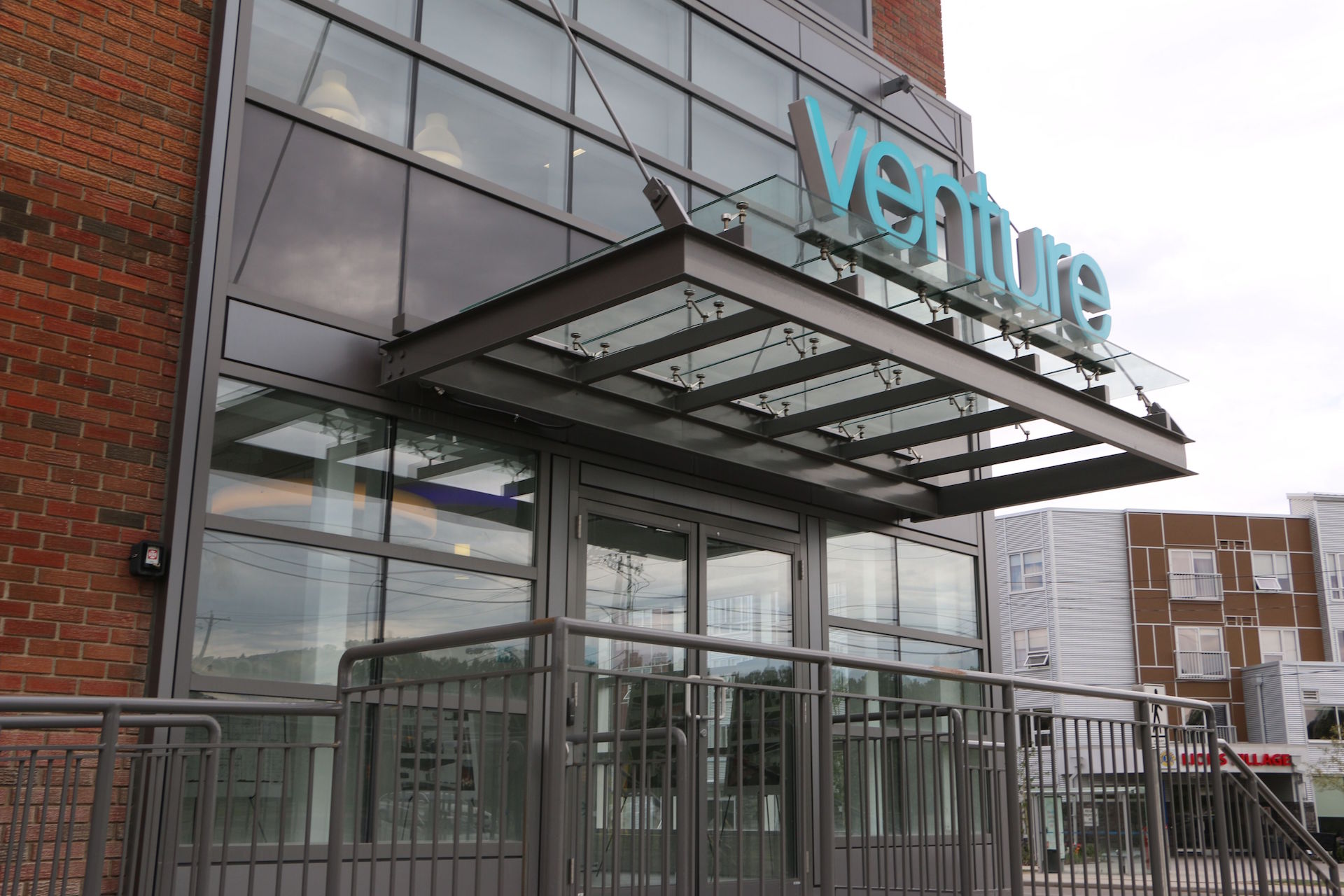 Alumicor 2500 series curtainwall with custom phenolic panels and spandrel, glass canopy, Alumicor doors