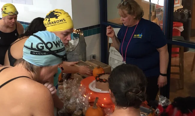 UVRay Susan Reid helps swimmers decide which item to take from the renowned awards table filled with amazing baked goods.