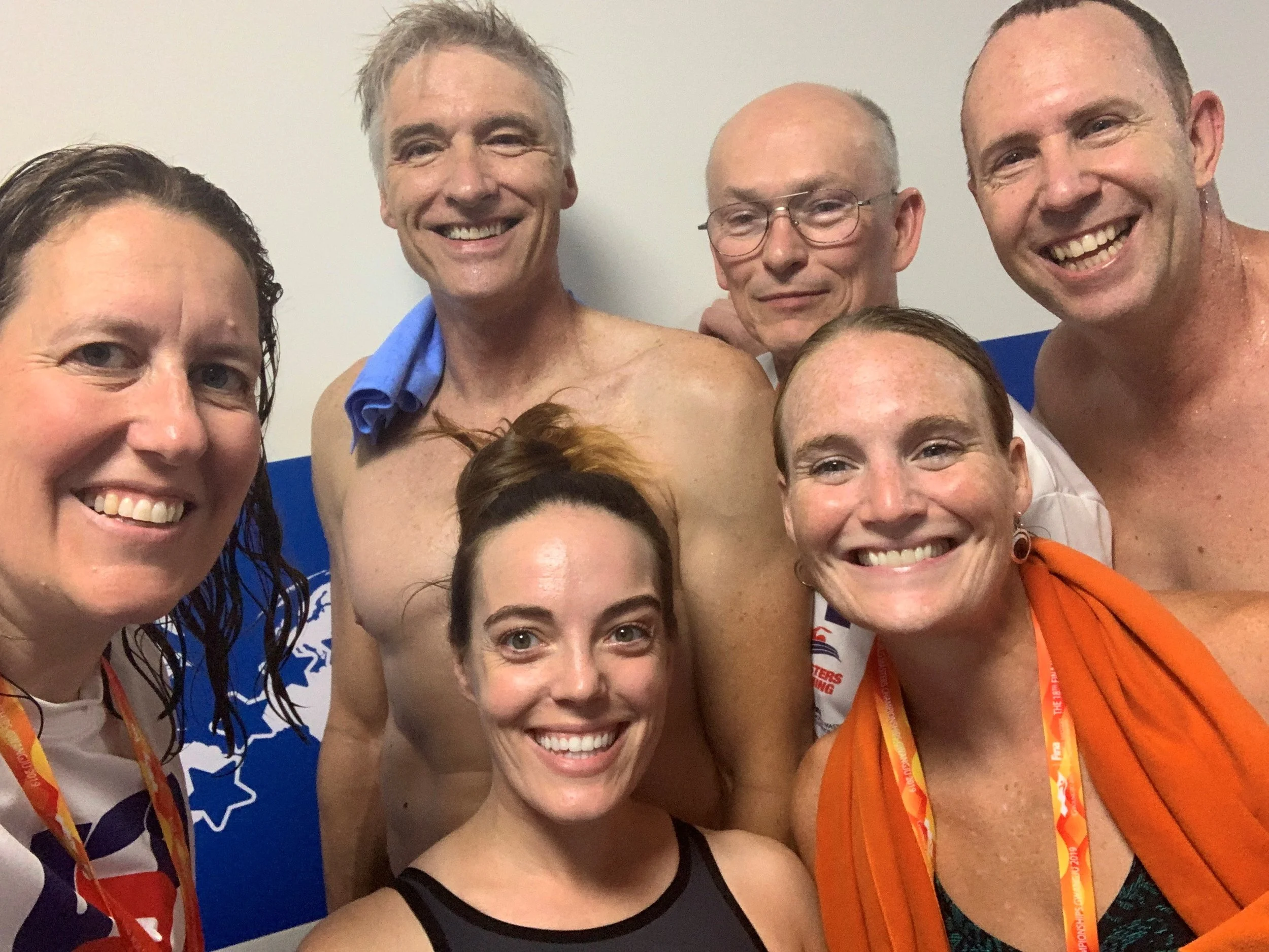 New England Swimmers connecting between the warm-up pool and the competition pool on day 3. L to R: back: Kysa Crusco, Bill Davis, Mark Kiel, Len van Greuning, front: Emily Cook, Mindy Williams