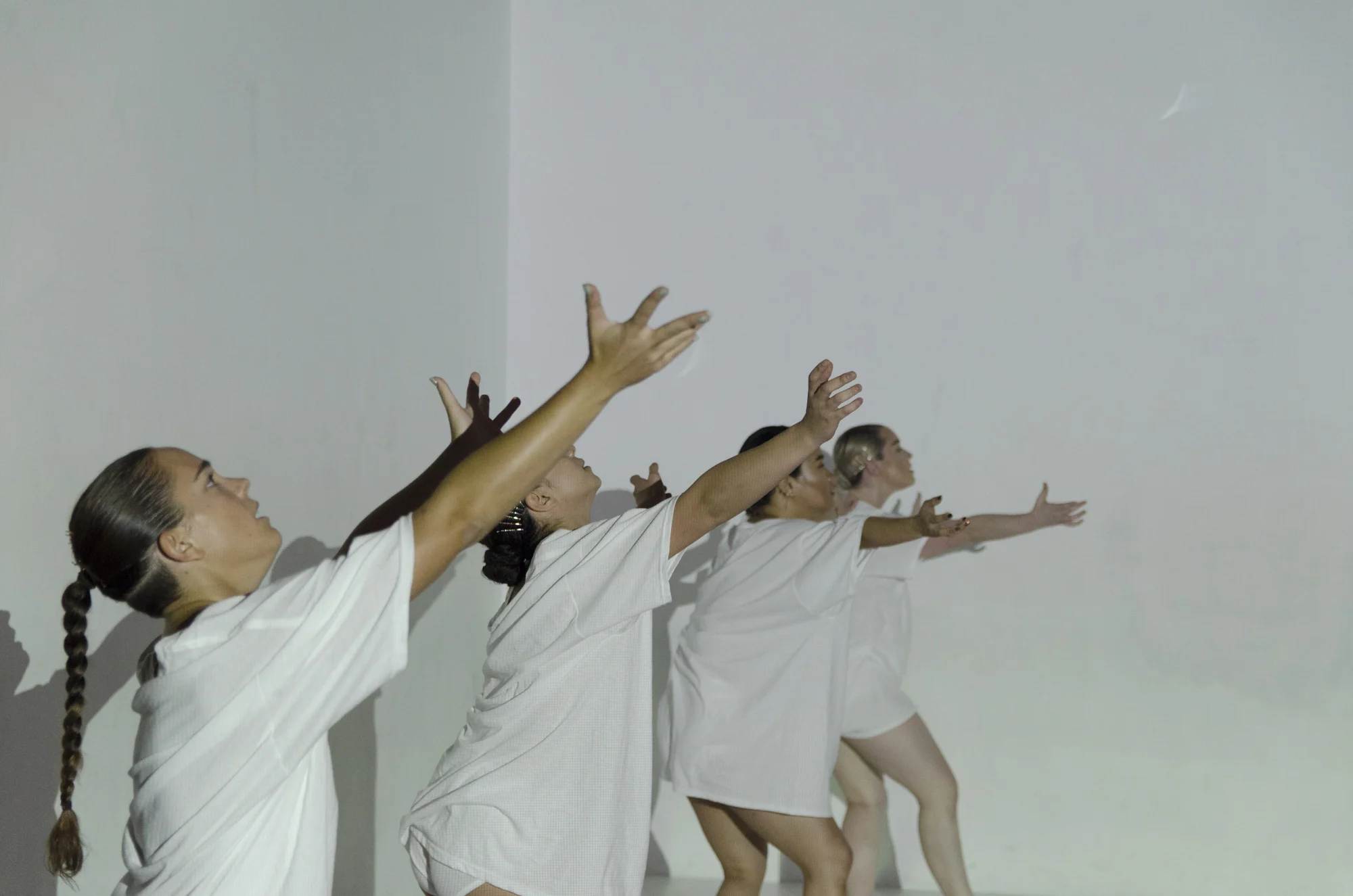 Four dancers with arms wide in a row, photo by Umi Akiyoshi. Photo from DOC Series in October 2017.