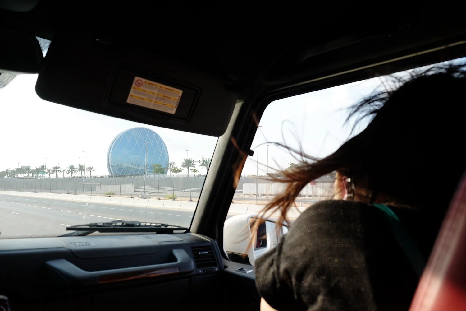 The daughter snapping a picture of the iconic Coin Building