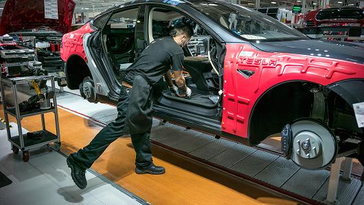 A worker assembles a car at Tesla's Fremont plant. Courtesy: CNBC