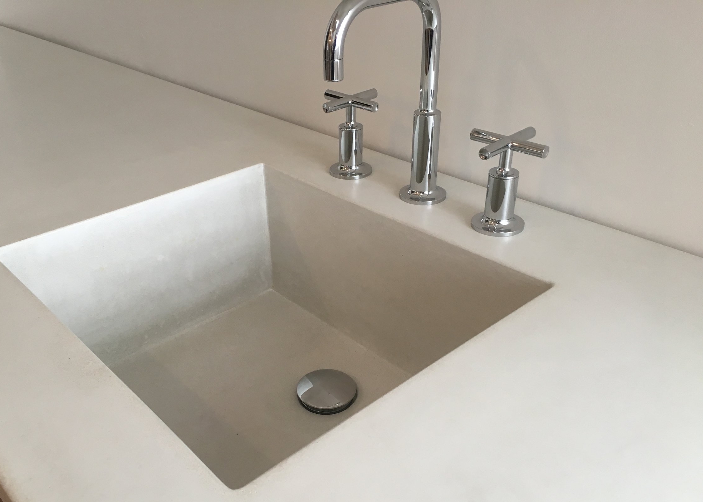 Arctic White bathroom vanity with integrated sink and canopy drain